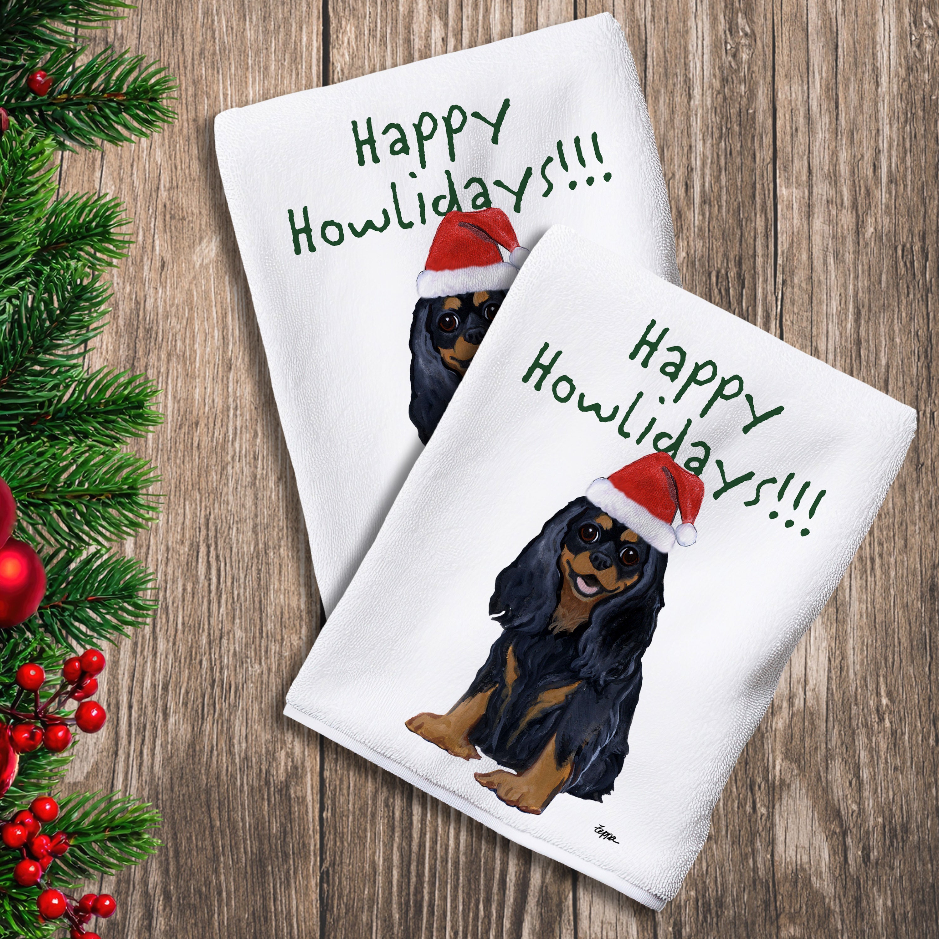2 Kitchen Towels with a Black and Tan Cavalier King Charles Spaniel in a Santa Hat and Happy Howlidays text.