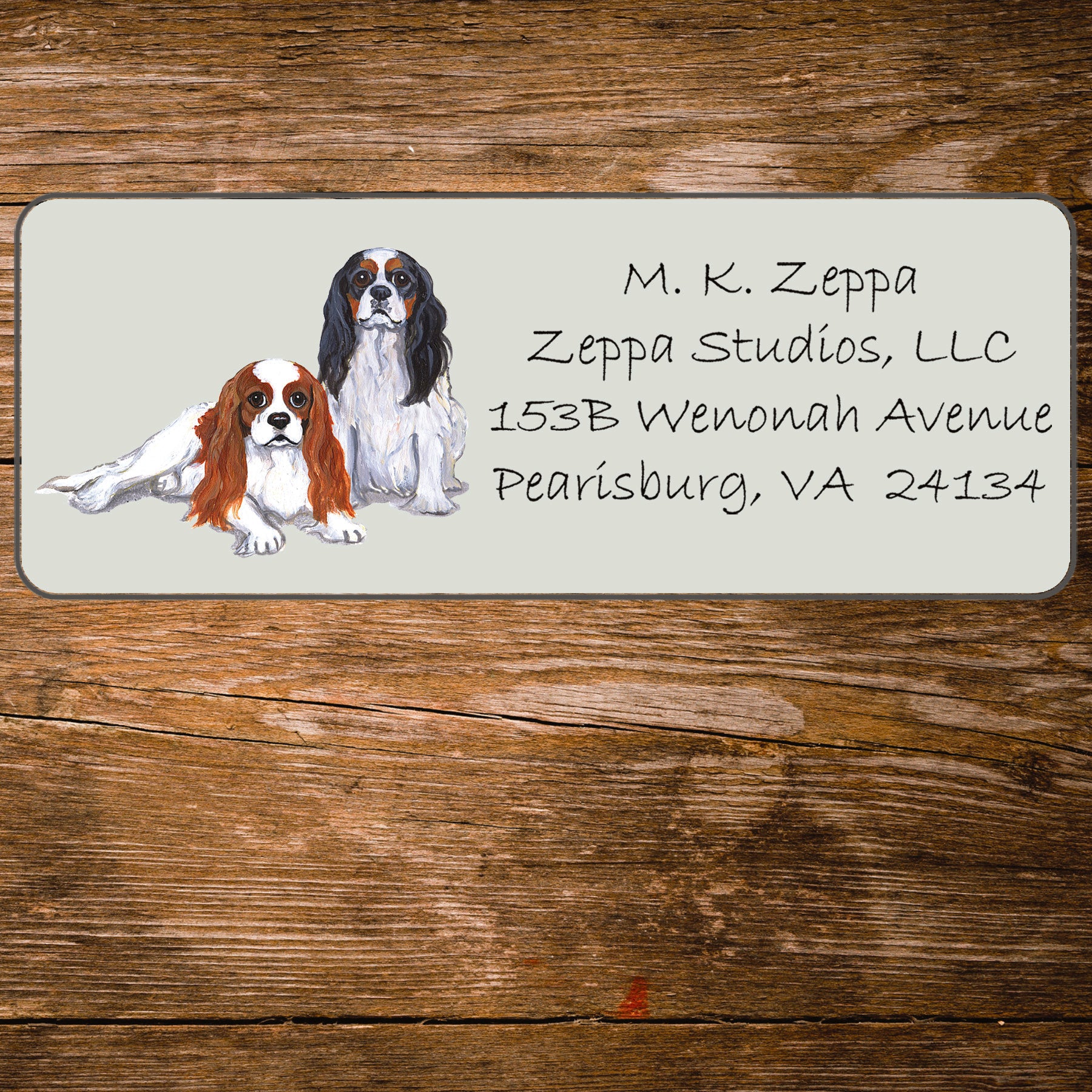 Return address label with a Cavalier King Charles Spaniel illustration.