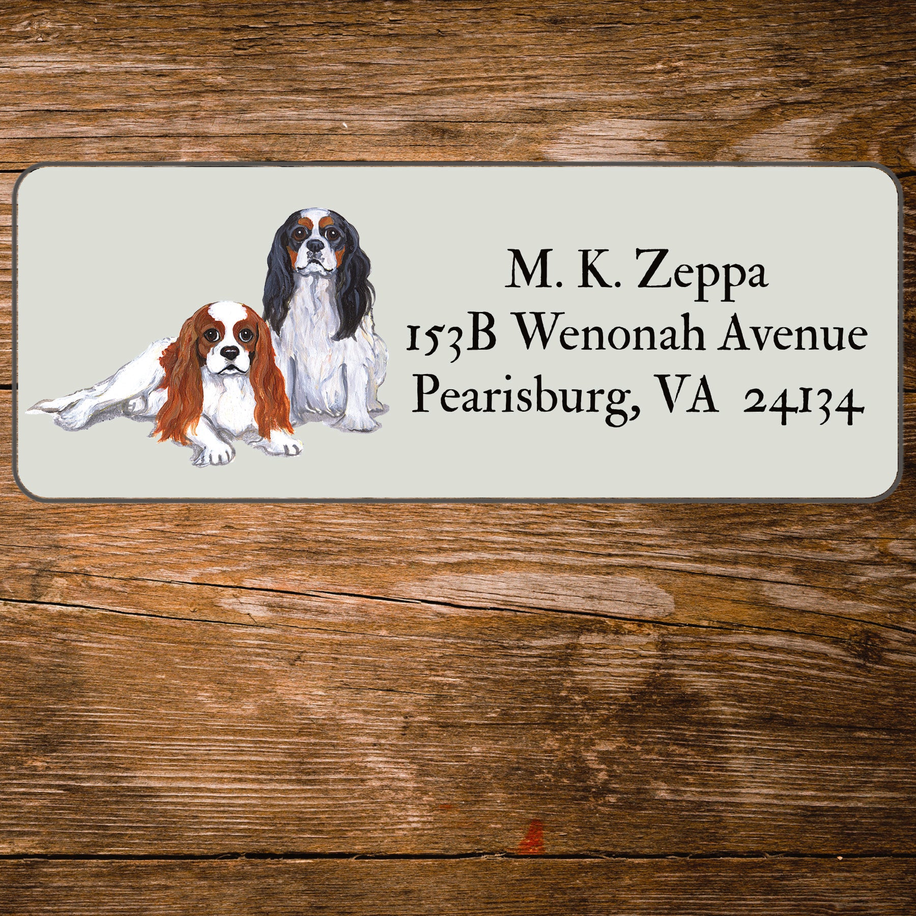 Return address label with a Cavalier King Charles Spaniel illustration.