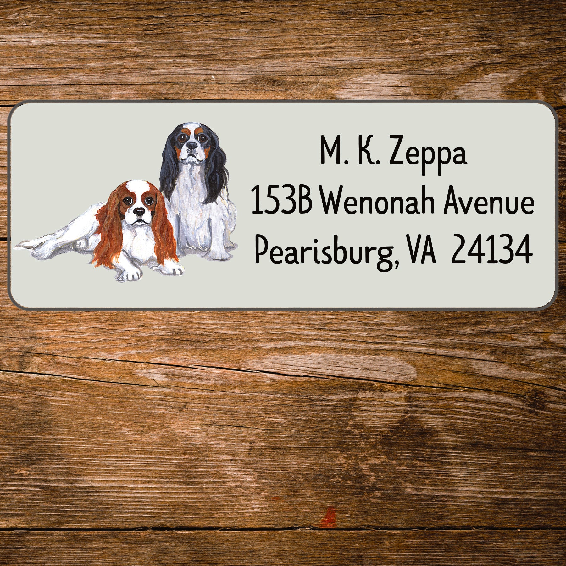 Return address label with a Cavalier King Charles Spaniel illustration.