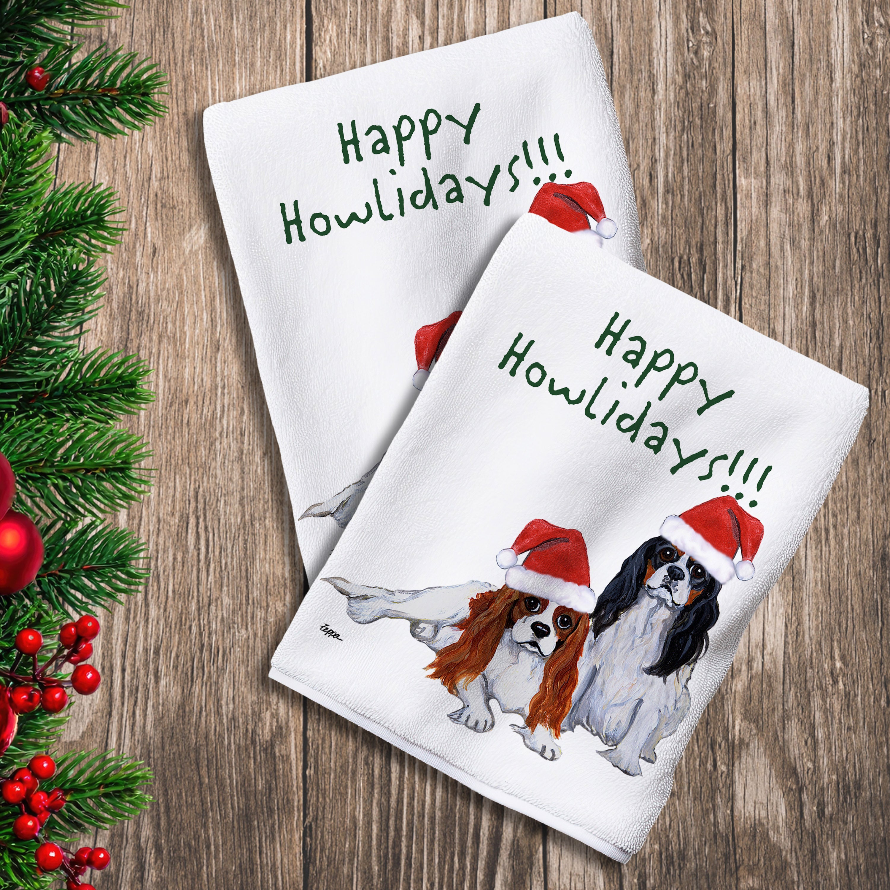 2 Kitchen Towels with a pair of Cavalier King Charles Spaniels in a Santa Hat and Happy Howlidays text.