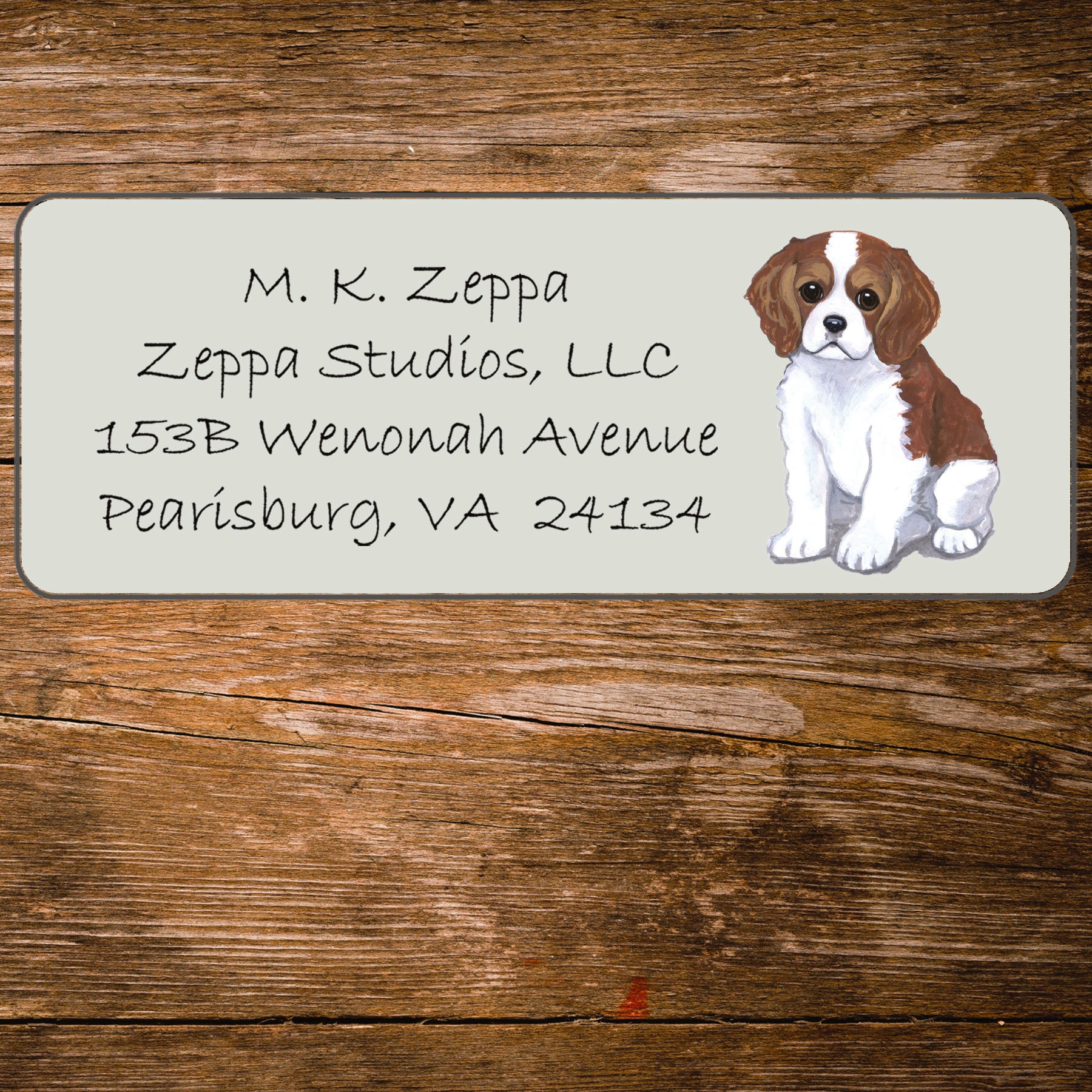 Return address label with a Cavalier King Charles Spaniel illustration.