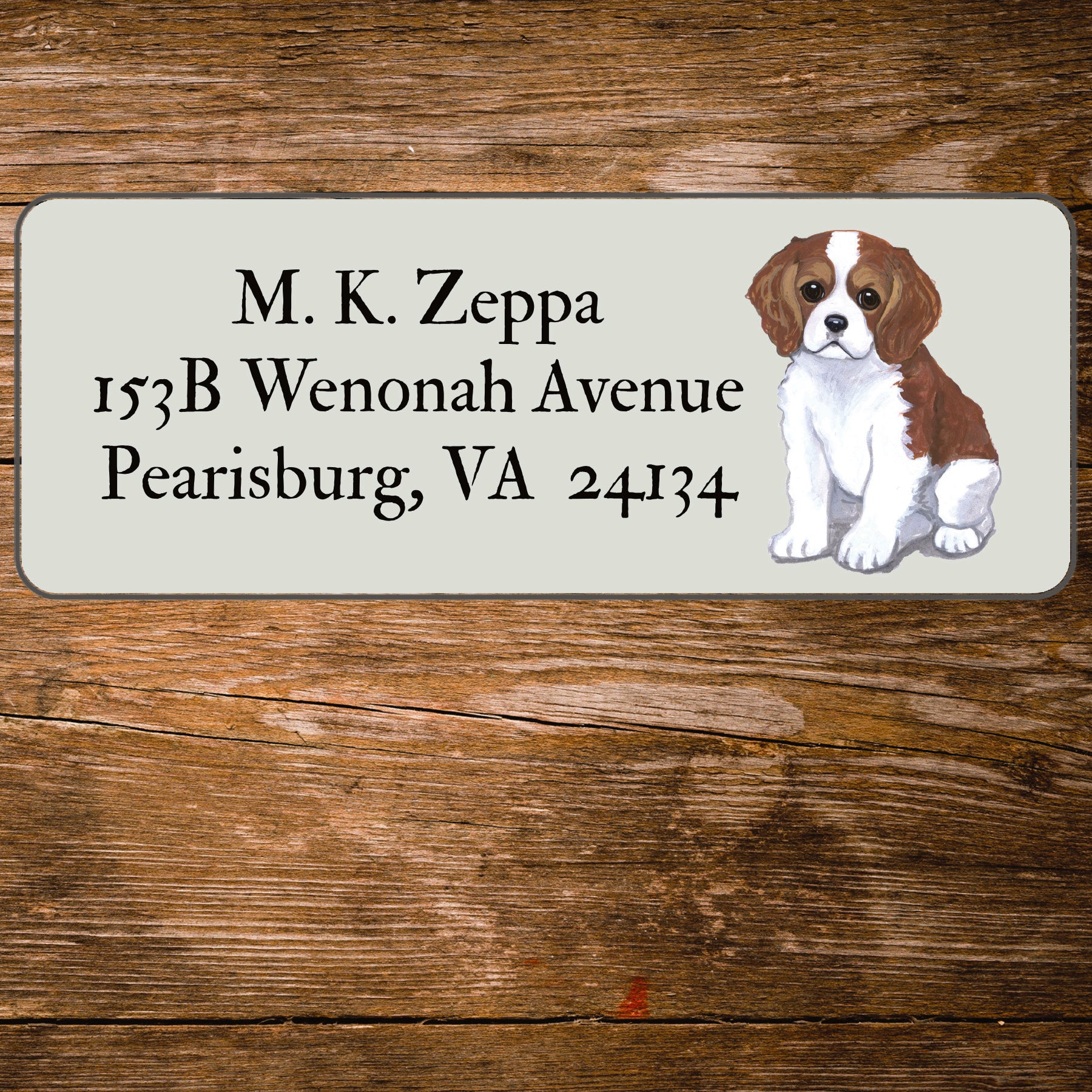 Return address label with a Cavalier King Charles Spaniel illustration.