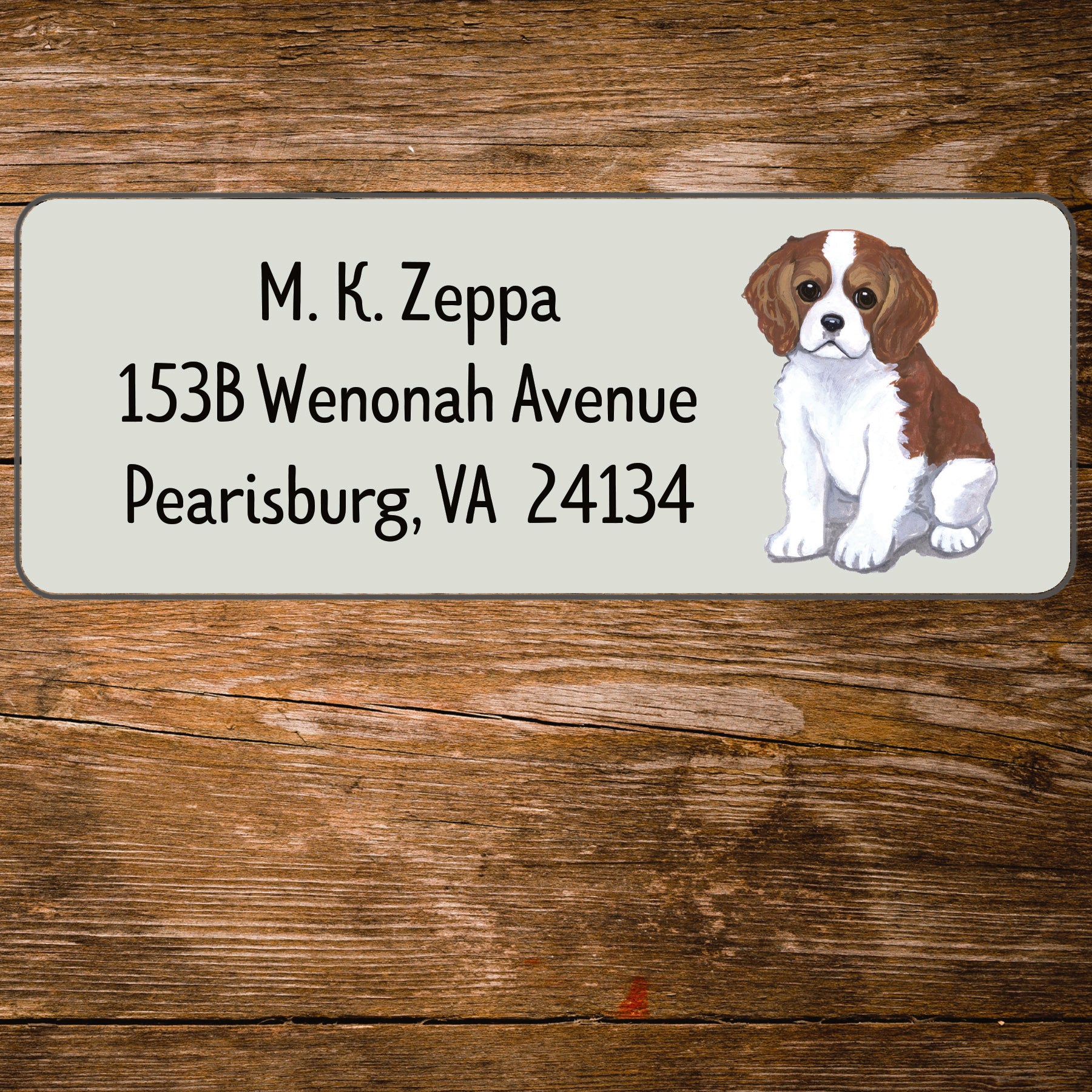 Return address label with a Cavalier King Charles Spaniel illustration.