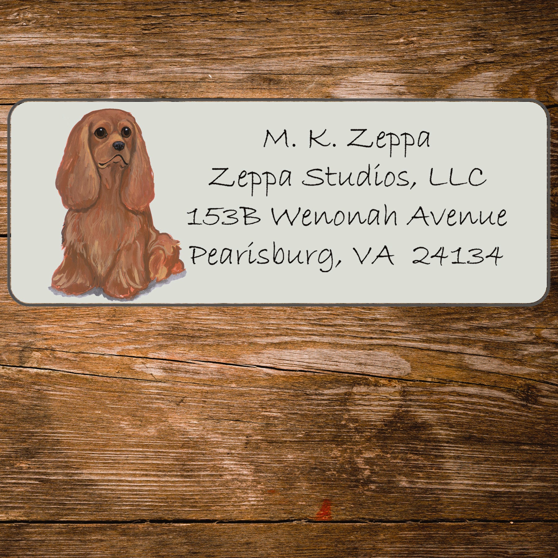 Return address label with a Cavalier King Charles Spaniel illustration.