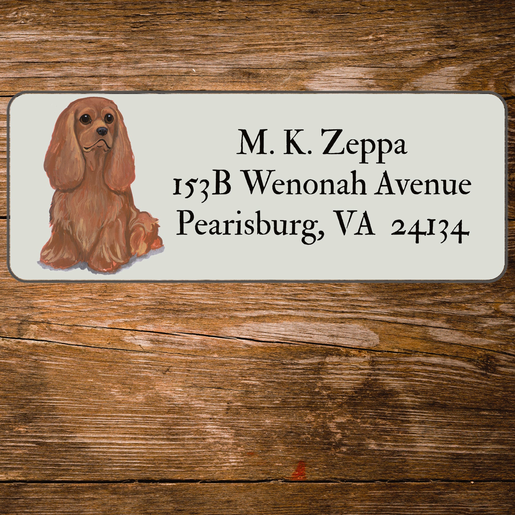 Return address label with a Cavalier King Charles Spaniel illustration.