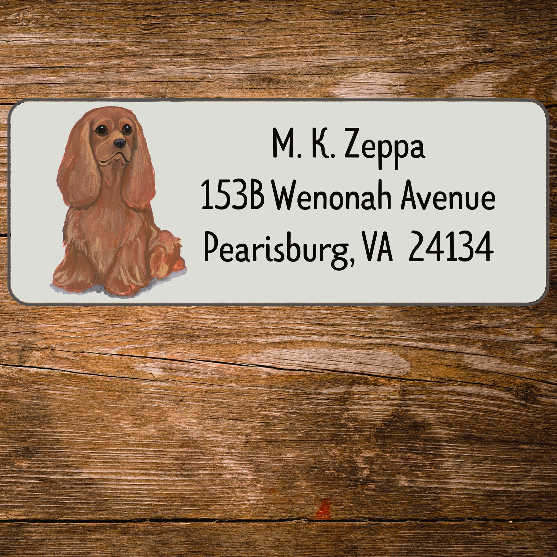 Return address label with a Cavalier King Charles Spaniel illustration.