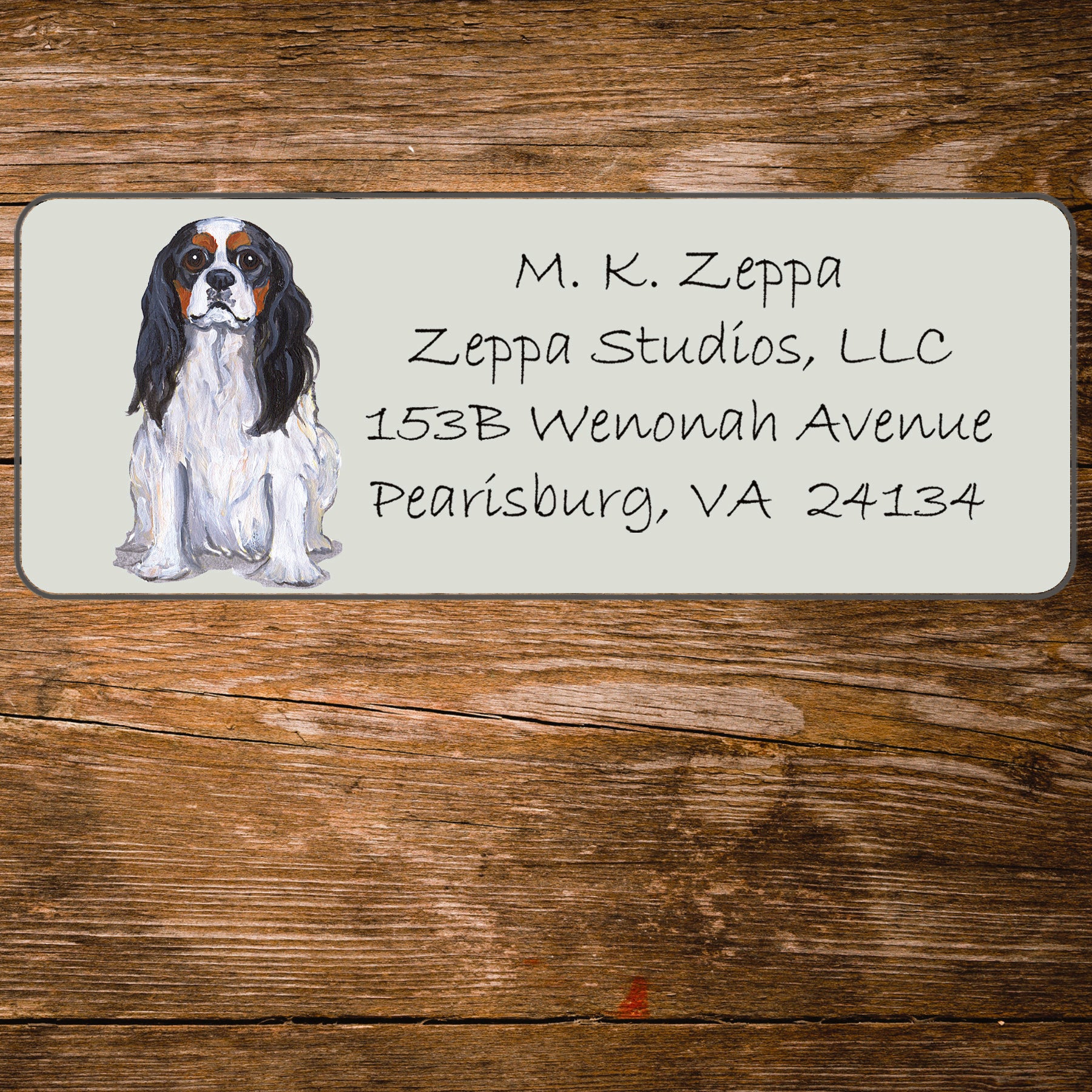 Return address label with a Cavalier King Charles Spaniel illustration.
