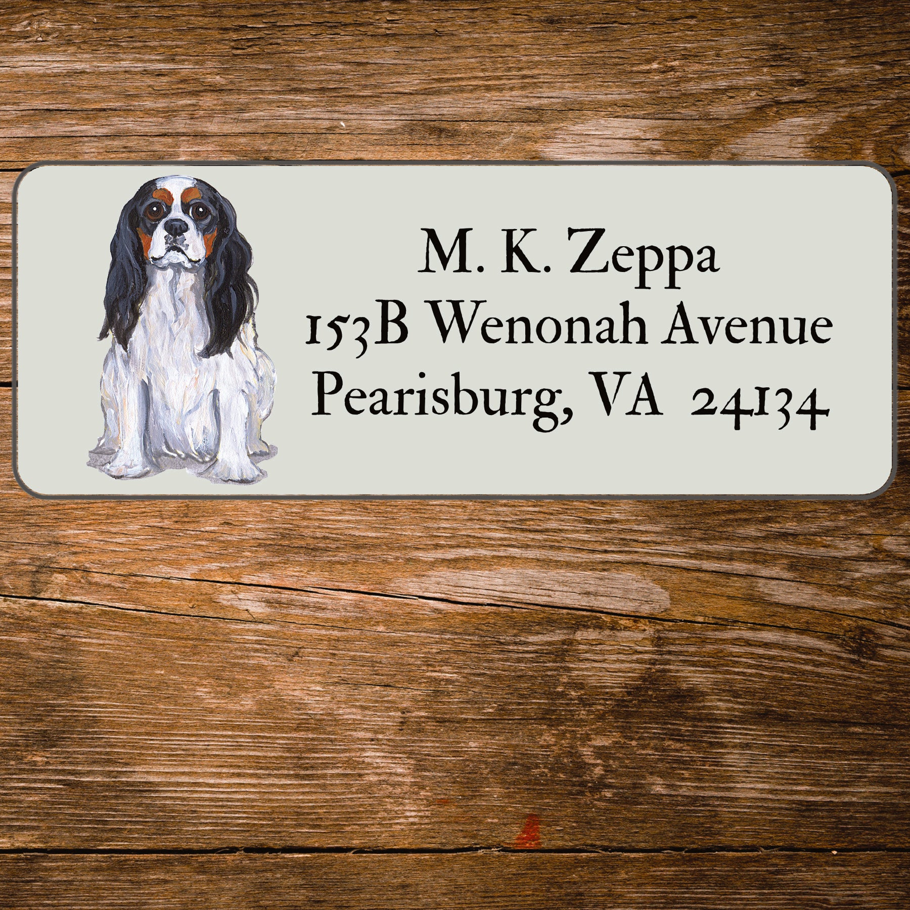 Return address label with a Cavalier King Charles Spaniel illustration.