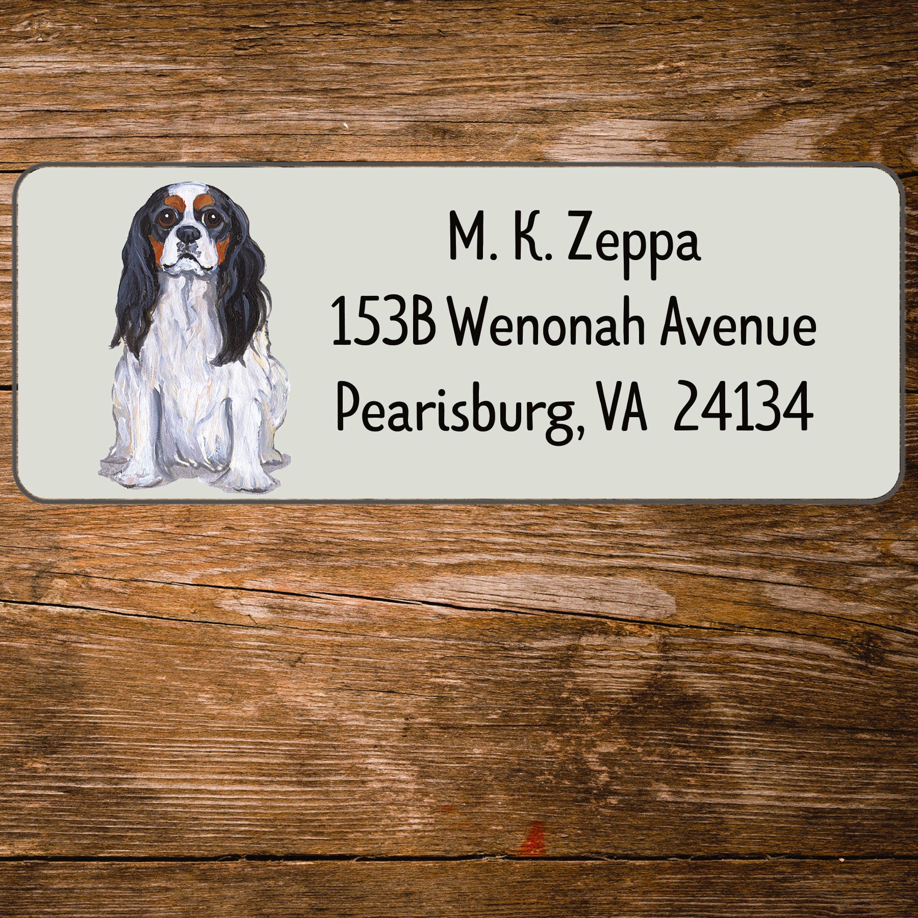 Return address label with a Cavalier King Charles Spaniel illustration.