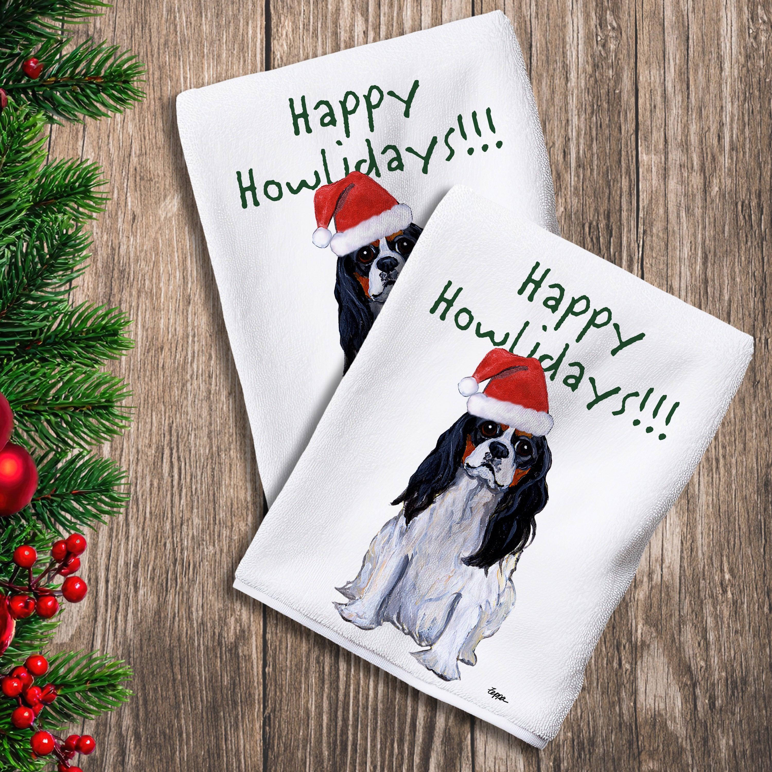 2 Kitchen Towels with a Tri Color Cavalier King Charles Spaniel in a Santa Hat and Happy Howlidays text.