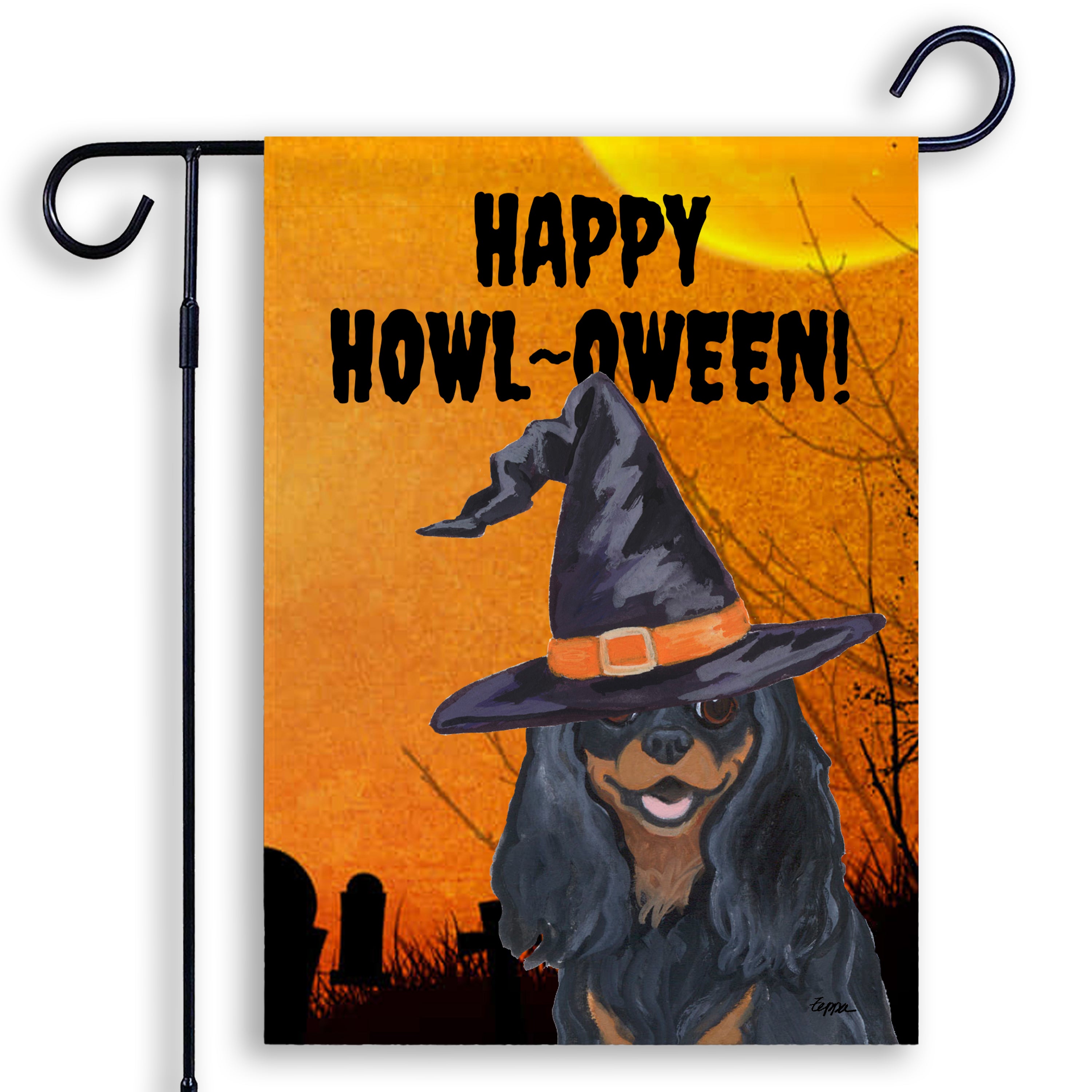 Halloween-themed garden flag with a Cavalier KIng Charles Spaniel wearing a witch hat and 'Happy Howl-Oween!' text on an orange background.