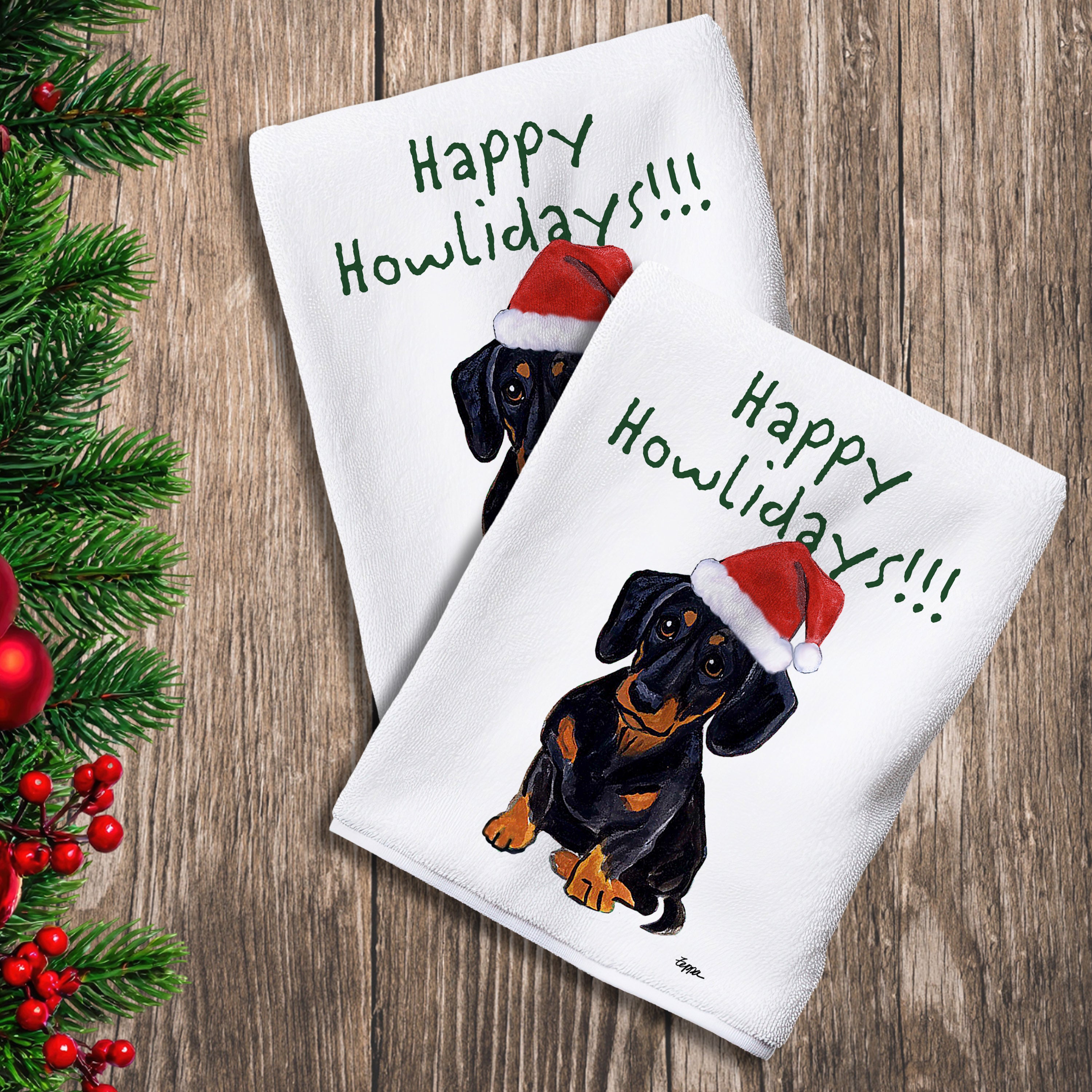 2 Kitchen Towels with a black and tan Dachshund in a Santa Hat and Happy Howlidays text. 