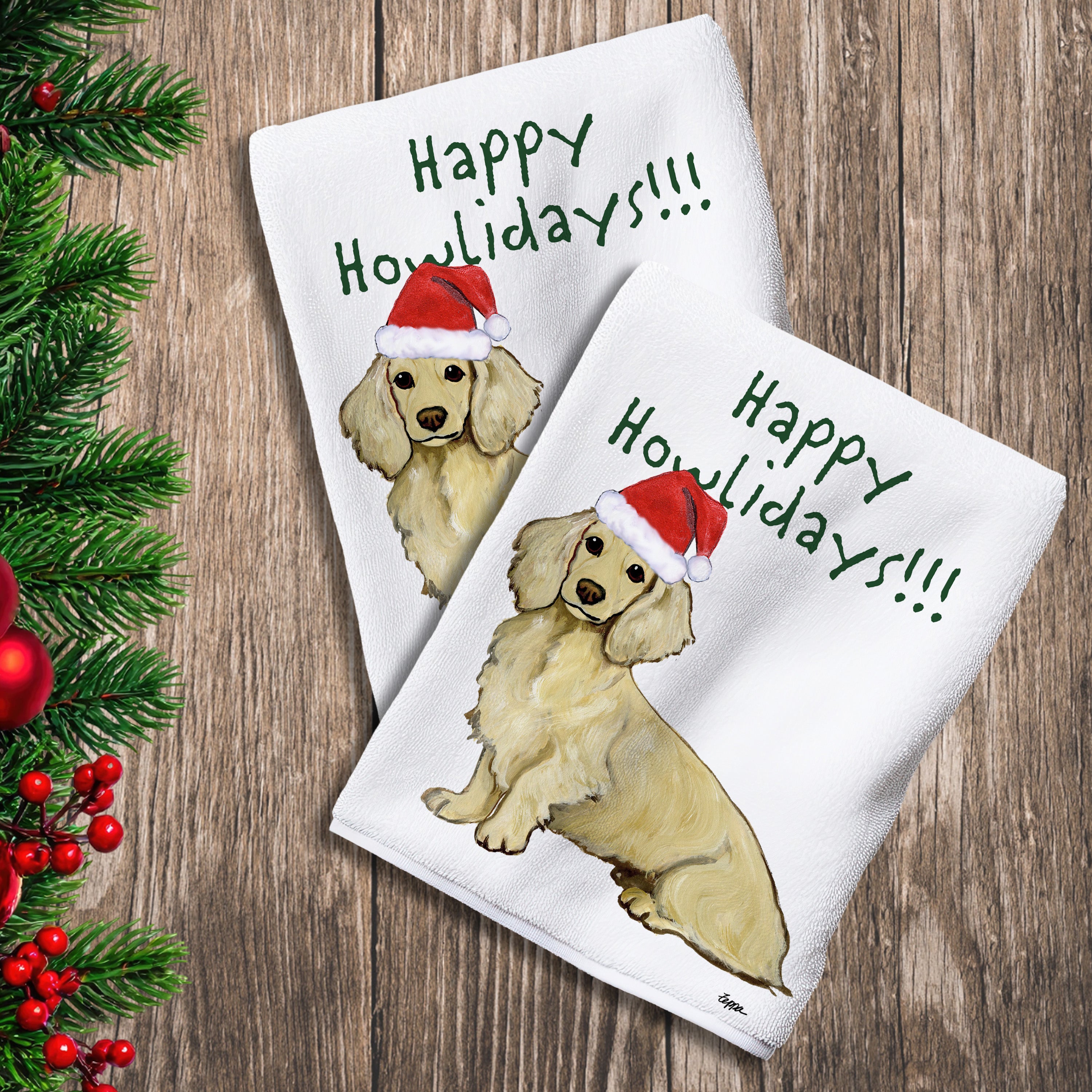 2 Kitchen Towels with a blonde longhaired Dachshund in a Santa Hat and Happy Howlidays text. 