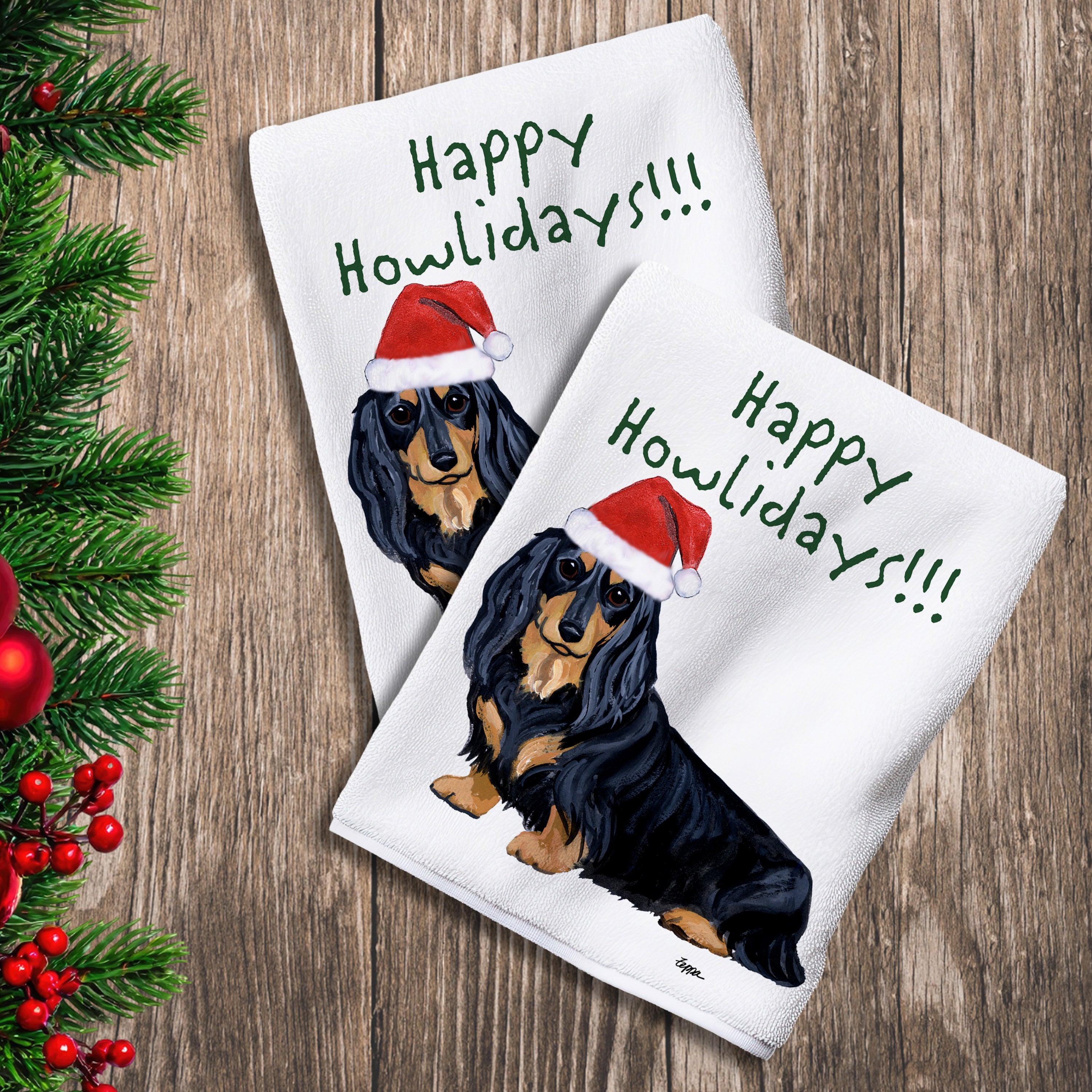 2 Kitchen Towels with a black and tan longhaired Dachshund in a Santa Hat and Happy Howlidays text. 