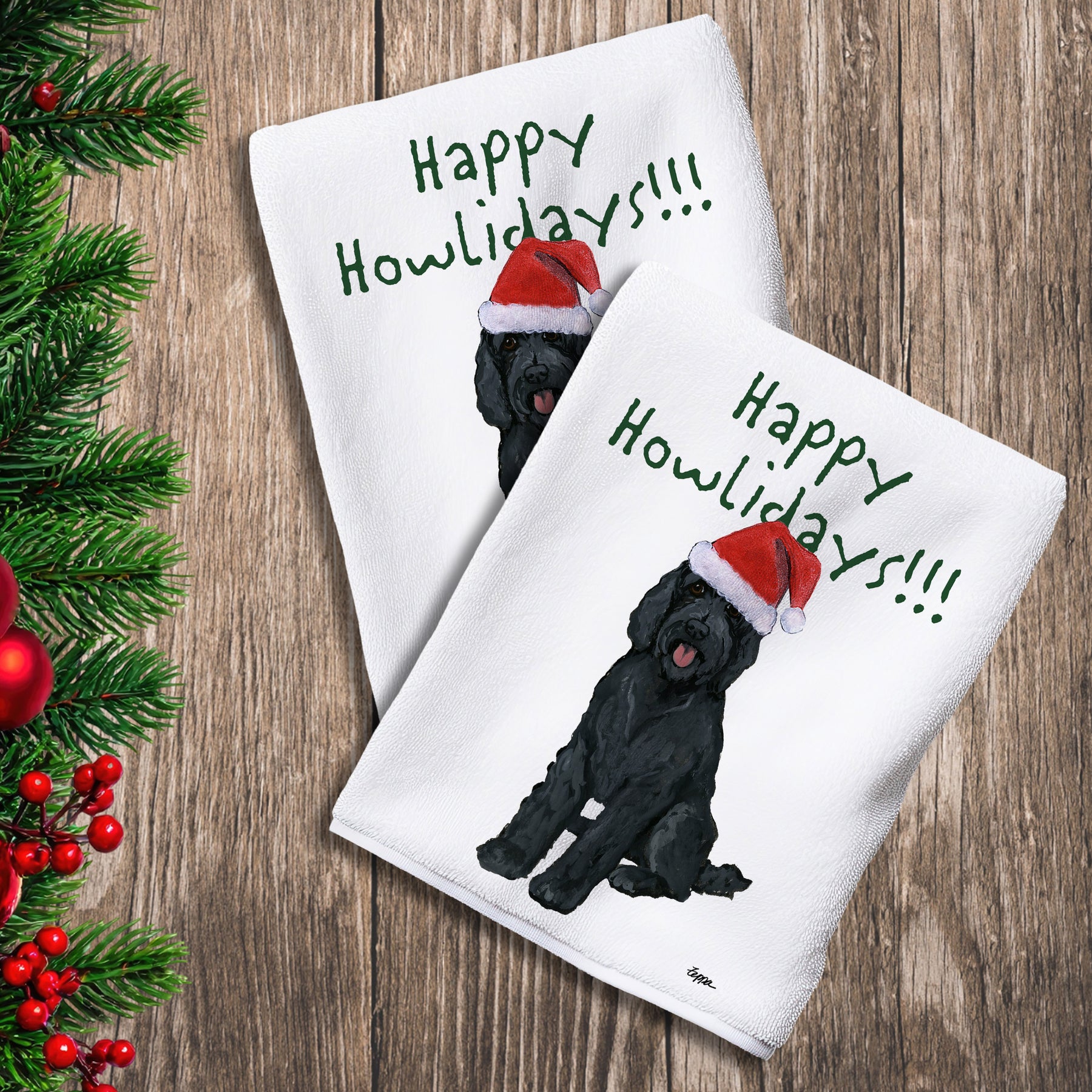 2 Kitchen Towels with a black Labradoodle in a Santa Hat and Happy Howlidays text. 