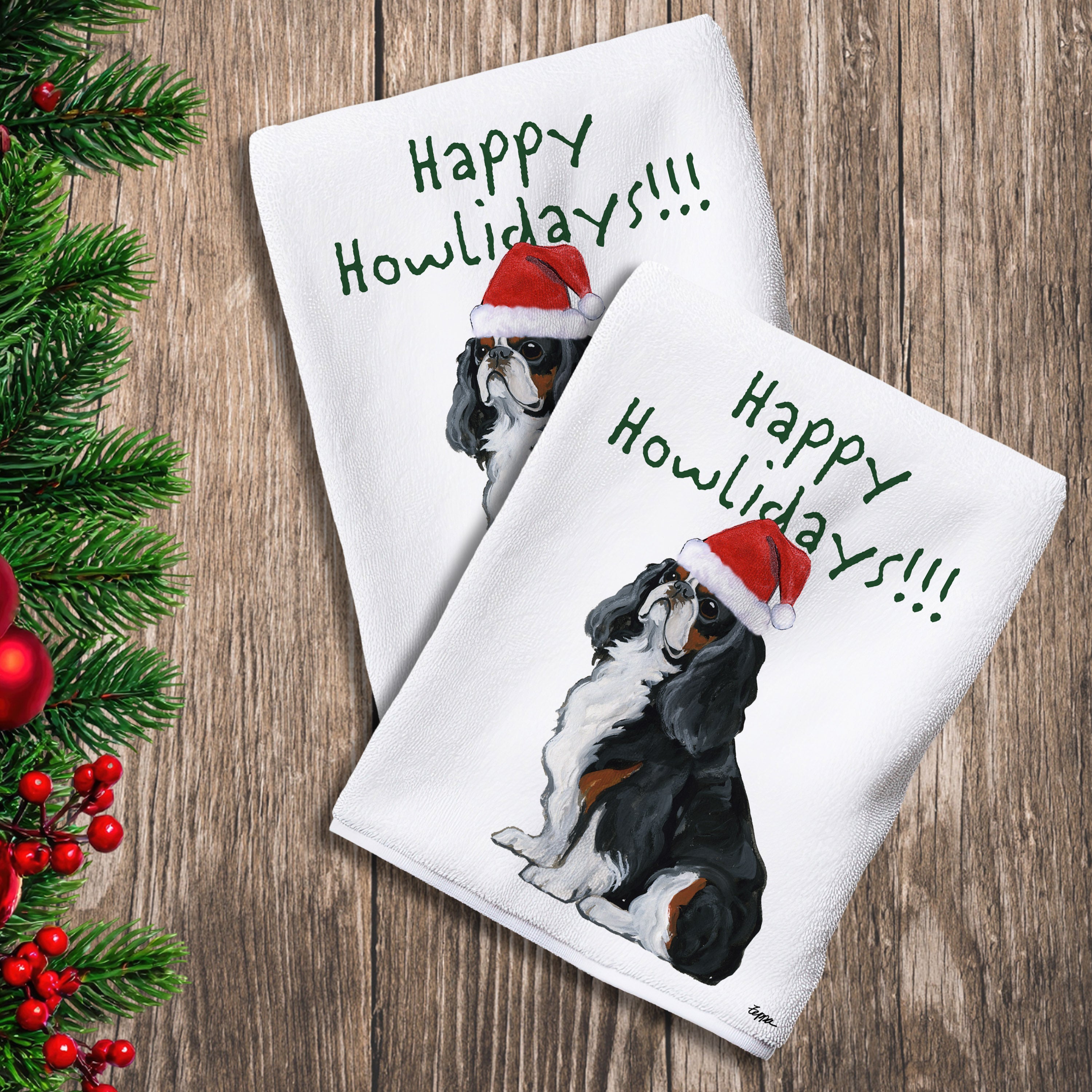 2 Kitchen Towels with a tri color English Toy Spaniel in a Santa Hat and Happy Howlidays text. 
