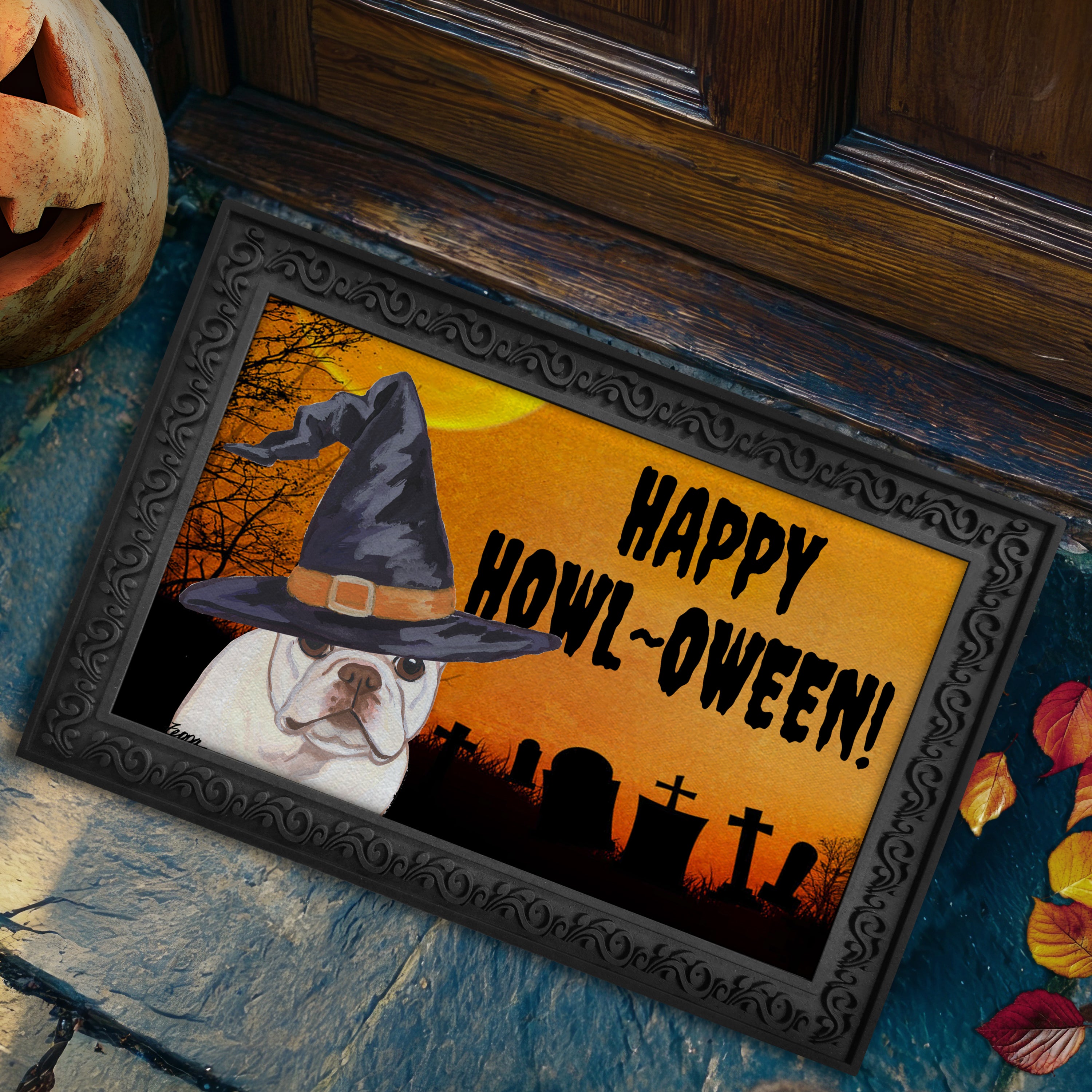 Halloween-themed doormat with a French Bulldog wearing a witch hat and 'Happy Howl-Oween!' text, placed on a stone surface.