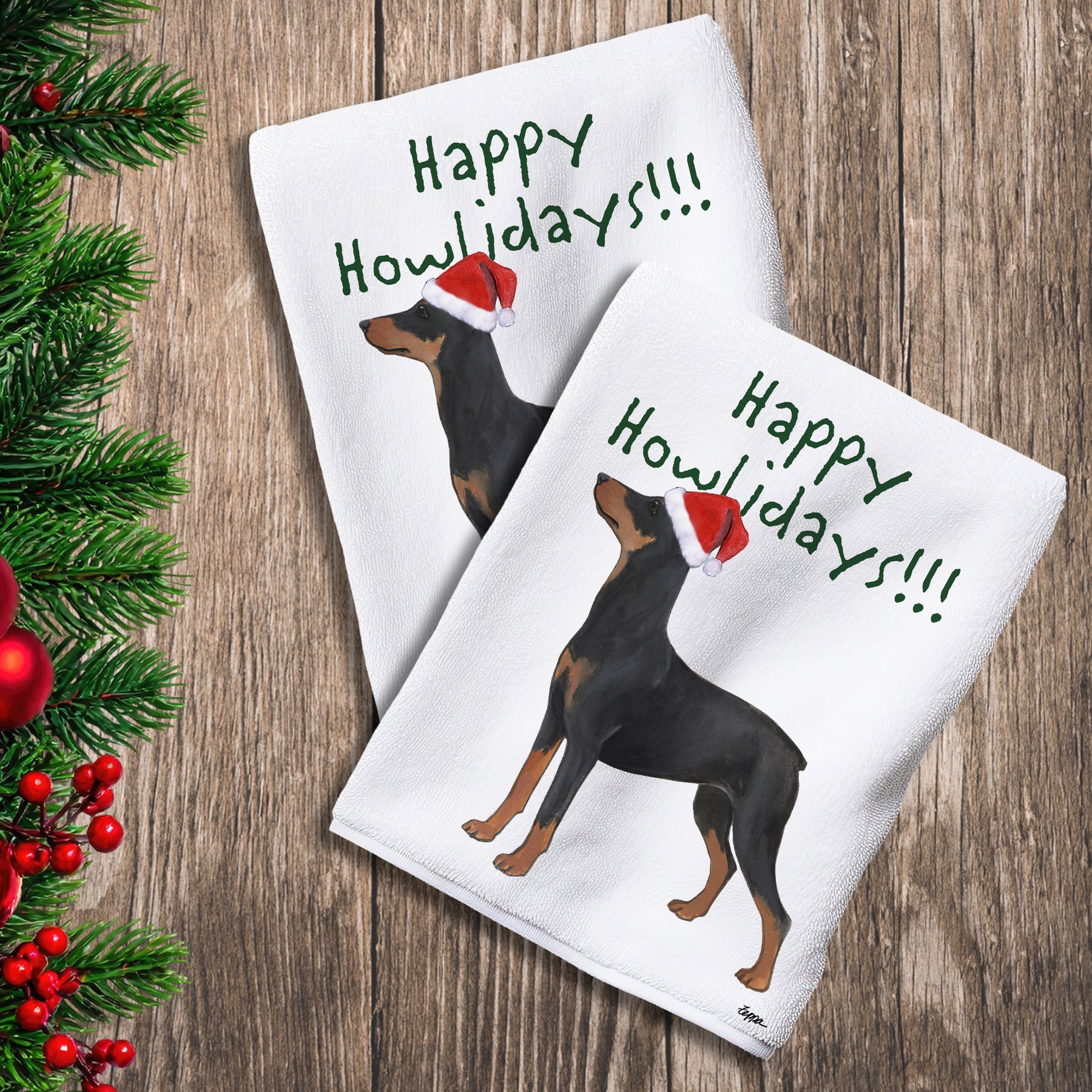 2 Kitchen Towels with a German Pinscher in a Santa Hat and Happy Howlidays text.