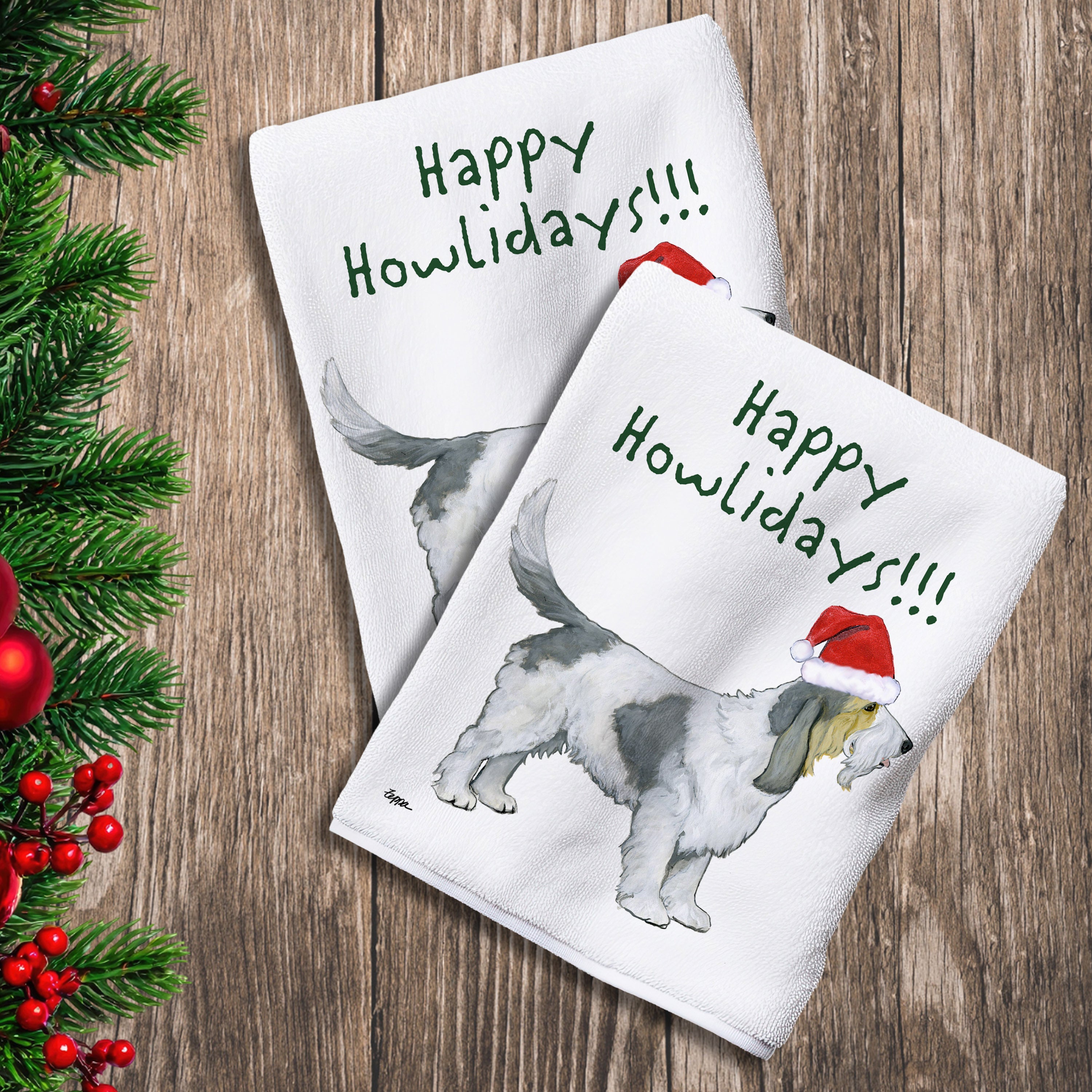 2 Kitchen Towels with a Grand Basset Griffon Vendeen in a Santa Hat and Happy Howlidays text.
