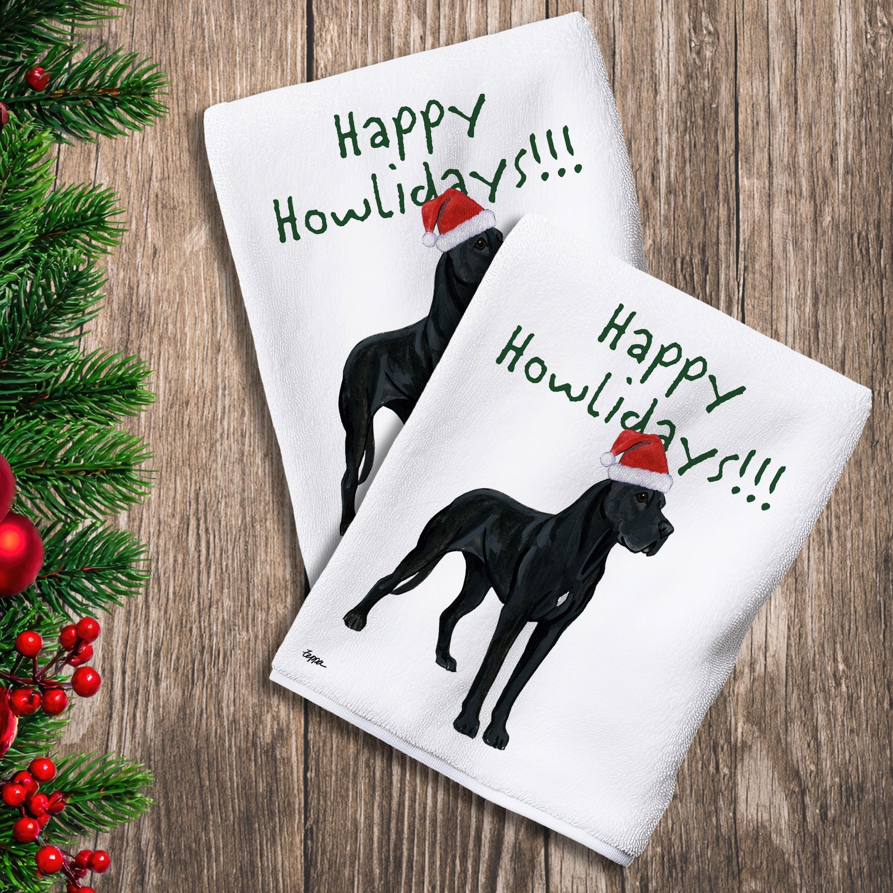 2 Kitchen Towels with a black Great Dane in a Santa Hat and Happy Howlidays text.