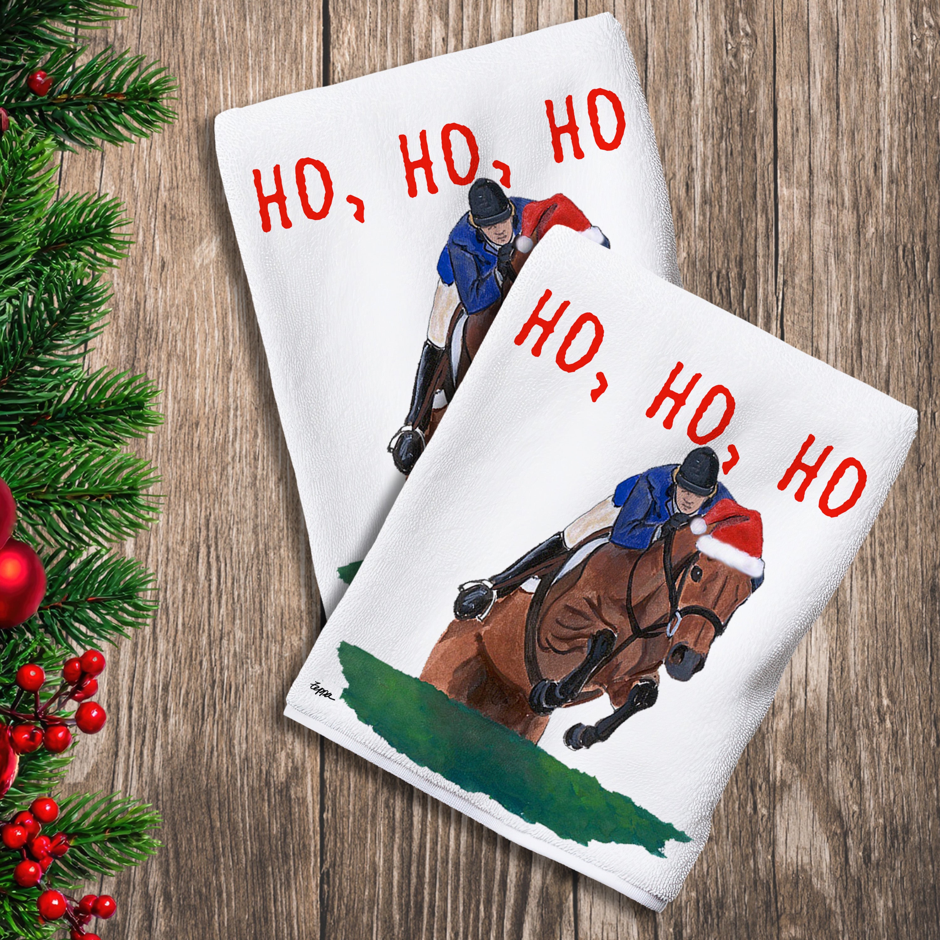 2 Kitchen Towels with a jumping horse  in a Santa hat and Ho Ho Ho text.
