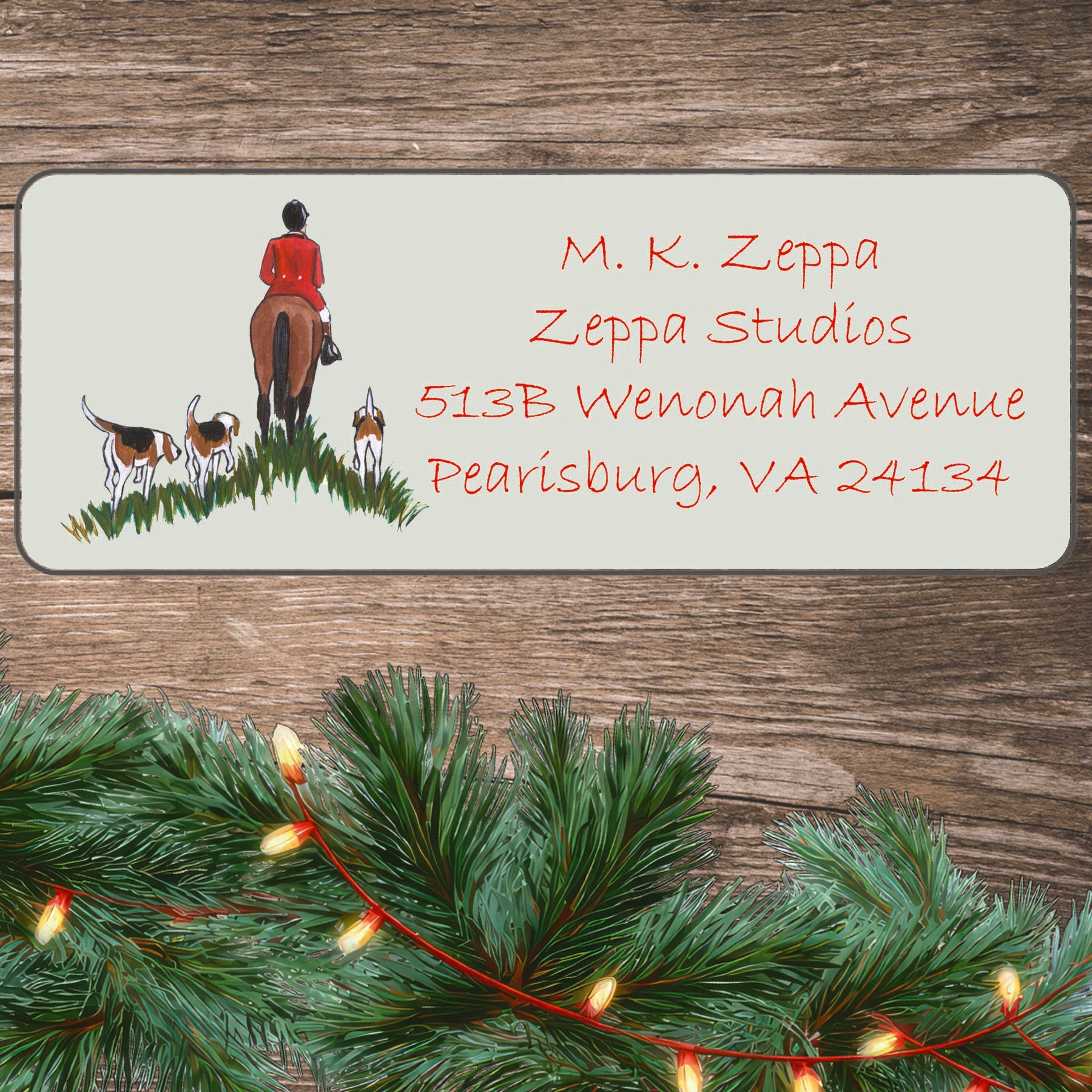 Holiday return address label with a hunt scene illustration on a board with greenery.
