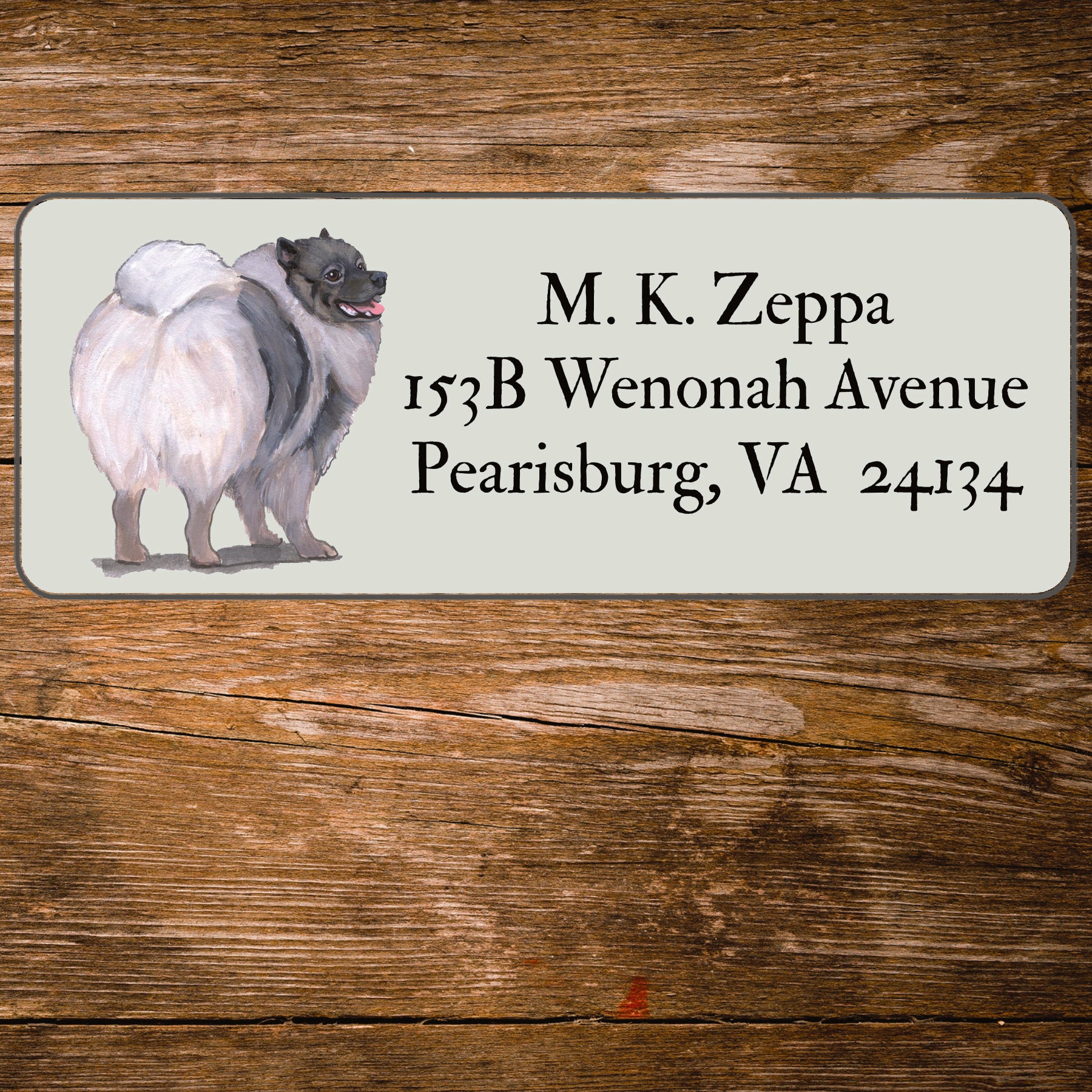 Return address label with a Keeshound illustration.
