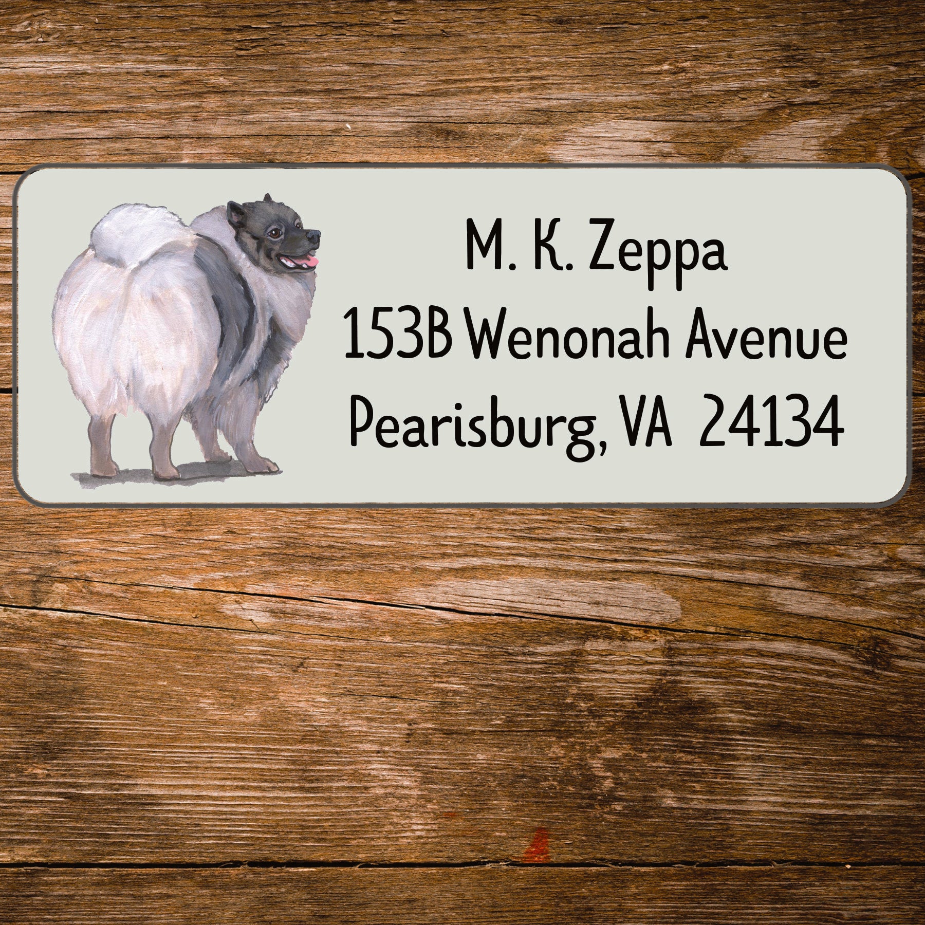Return address label with a Keeshound illustration.