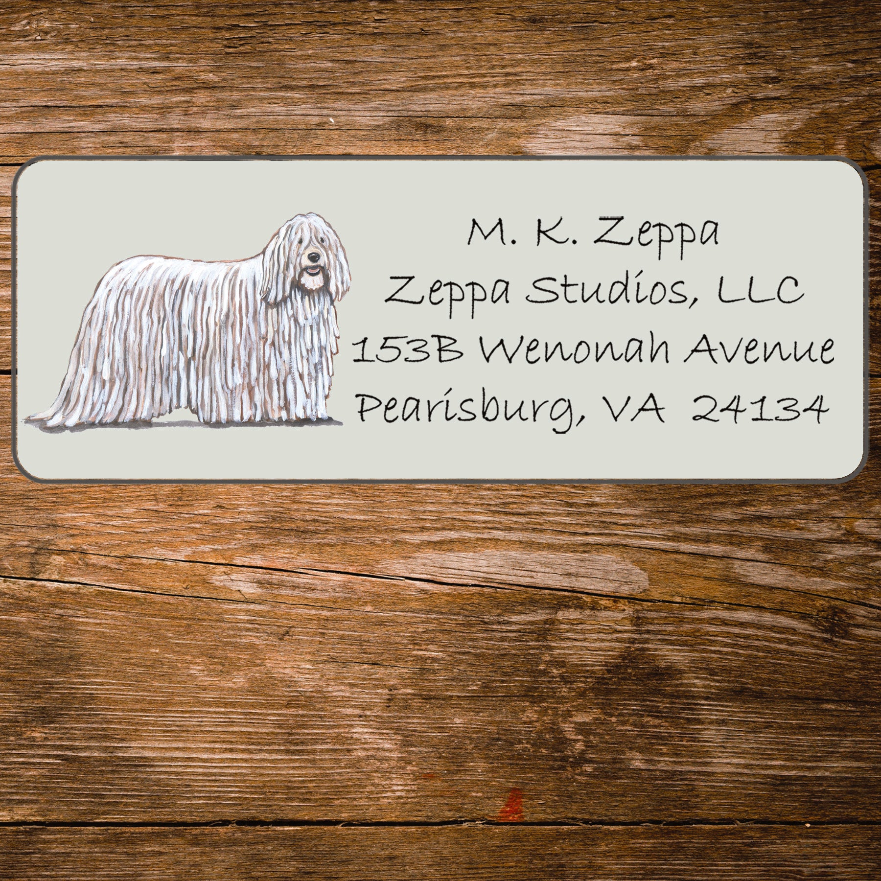 Return address label with a Komondor illustration.