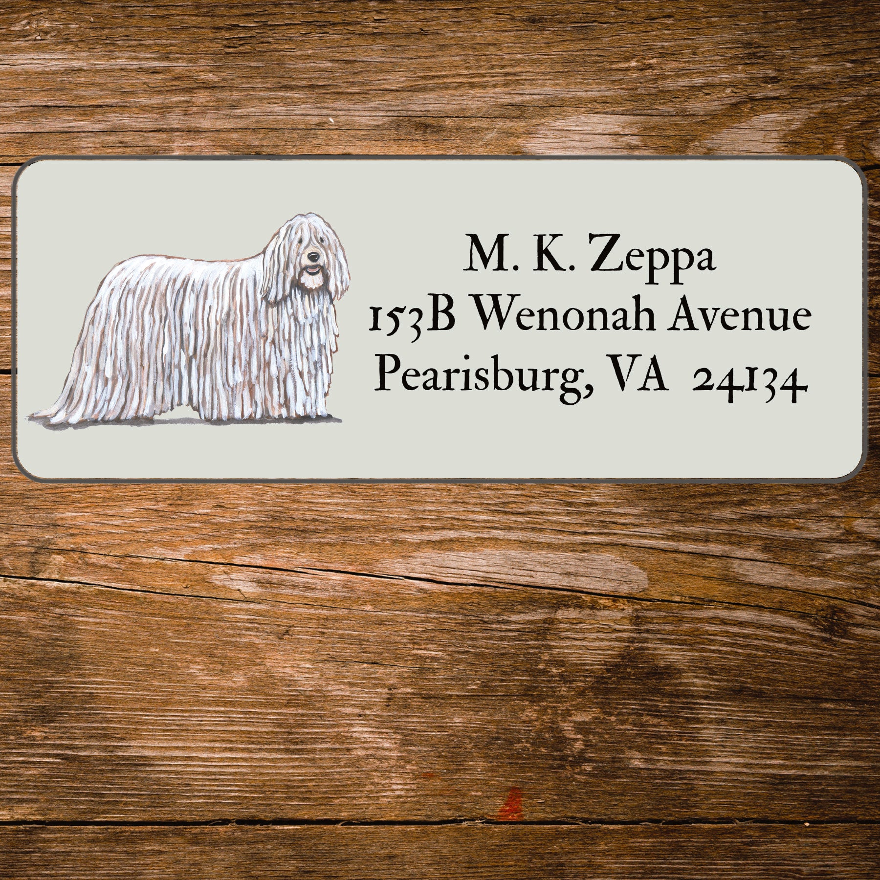 Return address label with a Komondor illustration.