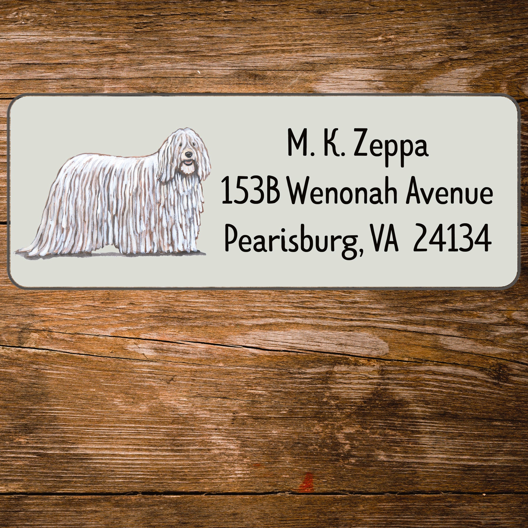 Return address label with a Komondor illustration.