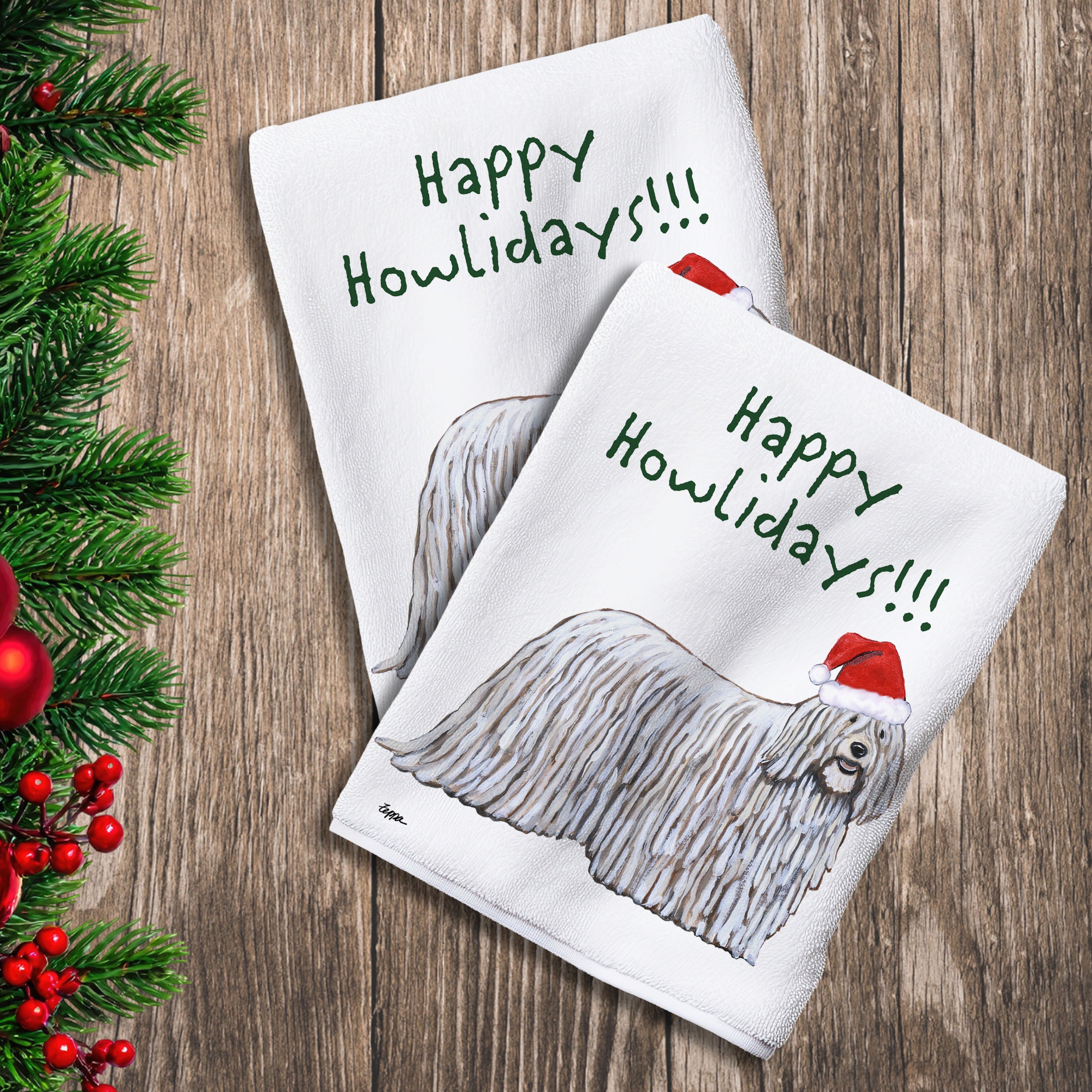 2 Kitchen Towels with a Komondor in a Santa Hat and Happy Howlidays text.