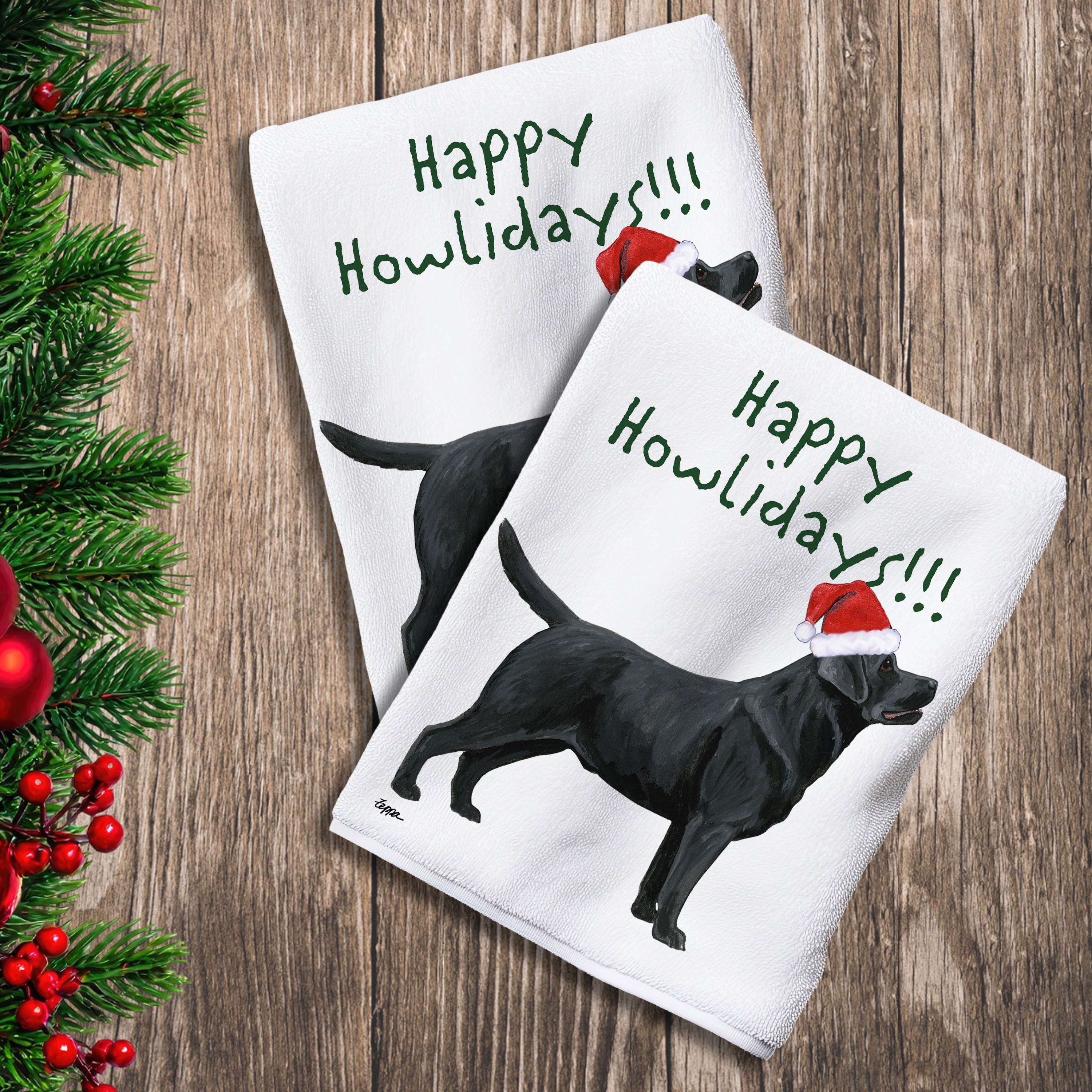 2 Kitchen Towels with a standing black Lab in a Santa Hat and Happy Howlidays text.