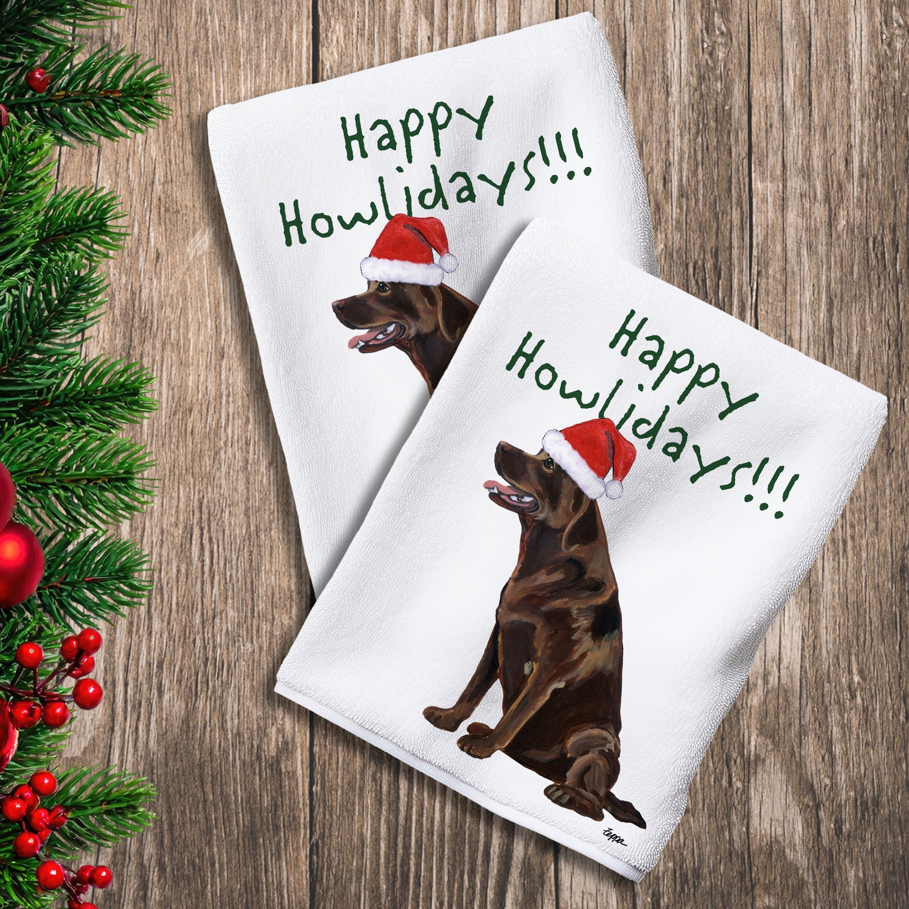 2 Kitchen Towels with a sitting chocolate Lab in a Santa Hat and Happy Howlidays text.