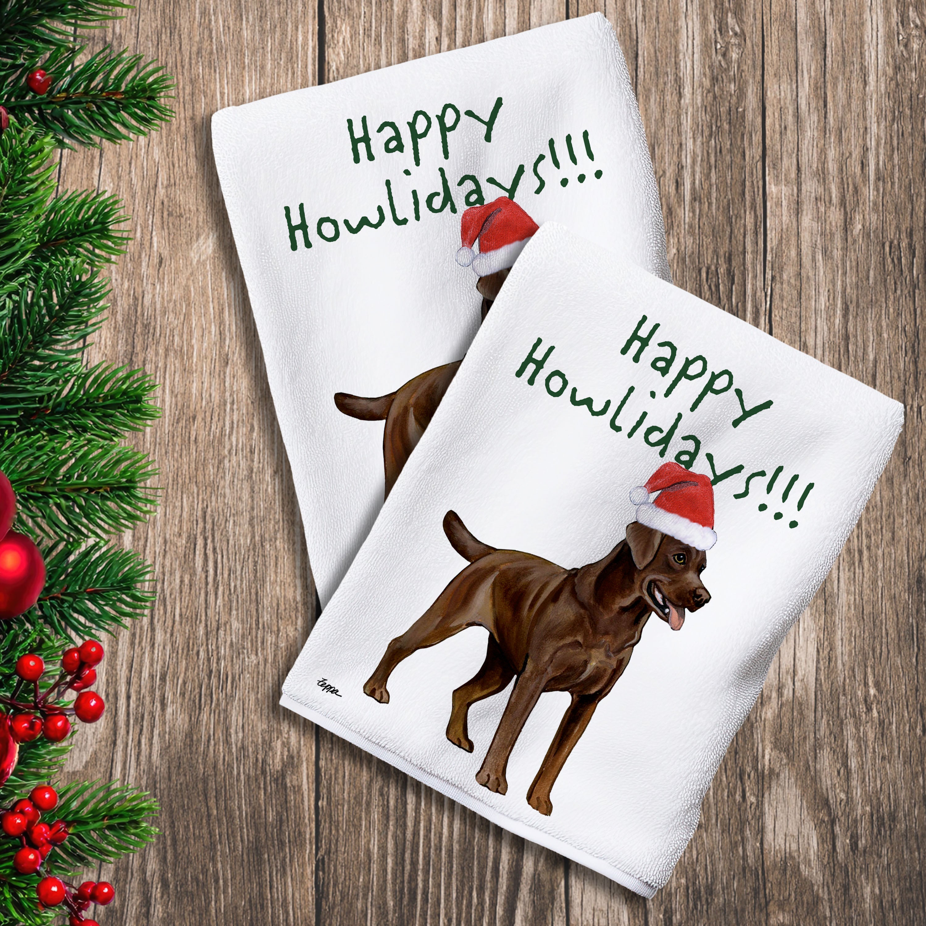 2 Kitchen Towels with a chocolate Lab in a Santa Hat and Happy Howlidays text.