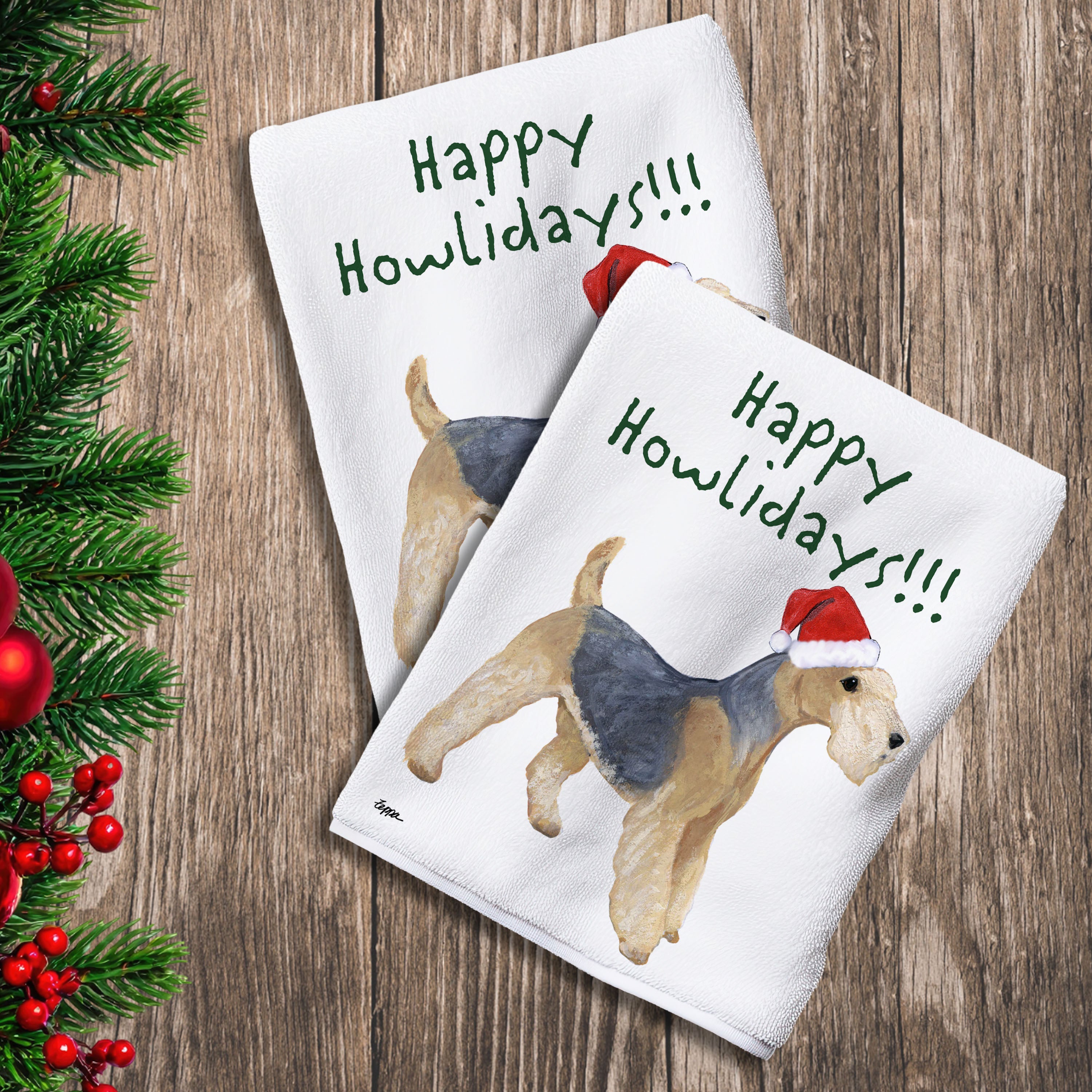 2 Kitchen Towels with a Lakeland Terrier in a Santa Hat and Happy Howlidays text.
