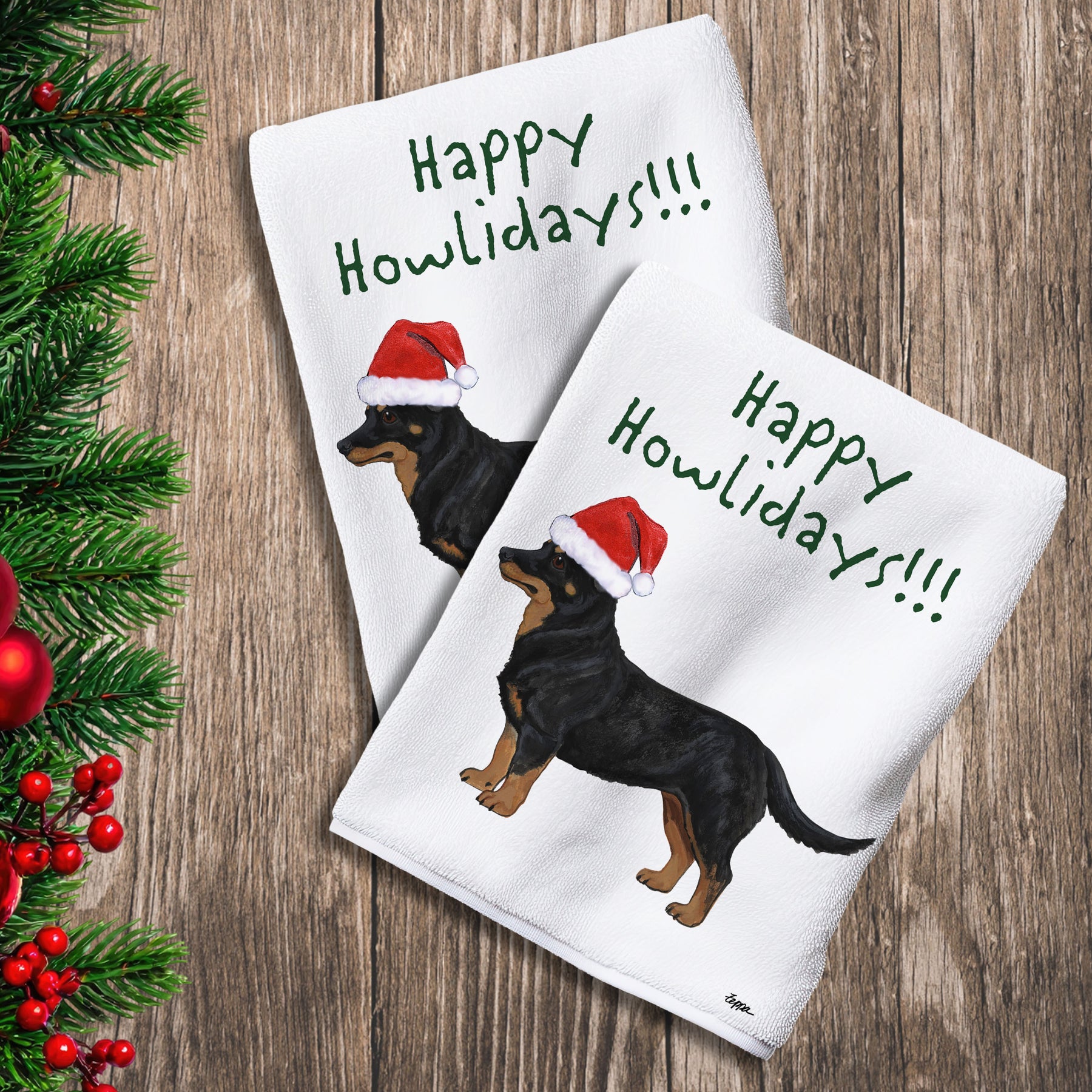 2 Kitchen Towels with a Lancashire Heeler in a Santa Hat and Happy Howlidays text.
