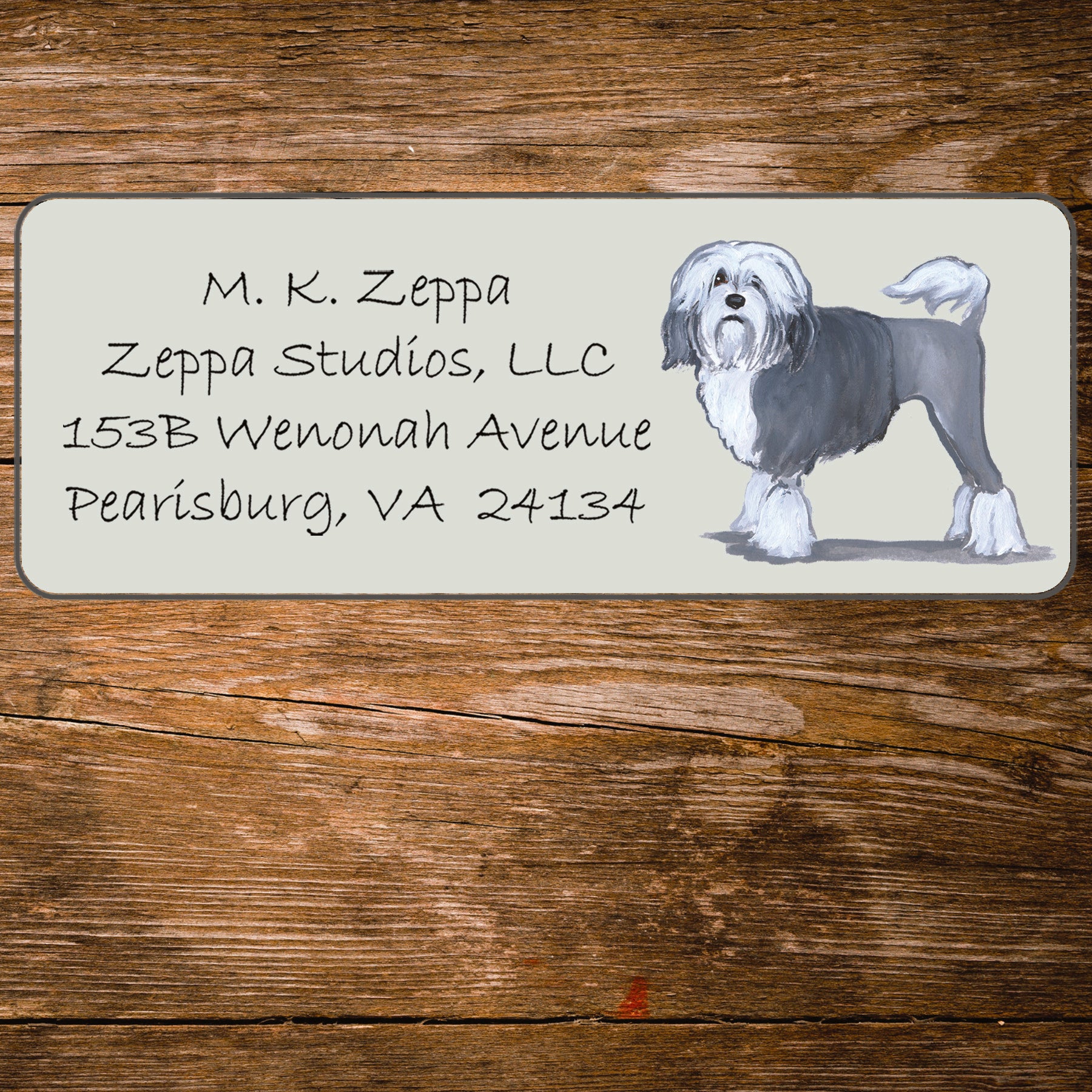 Return address label with a Lowchen illustration.