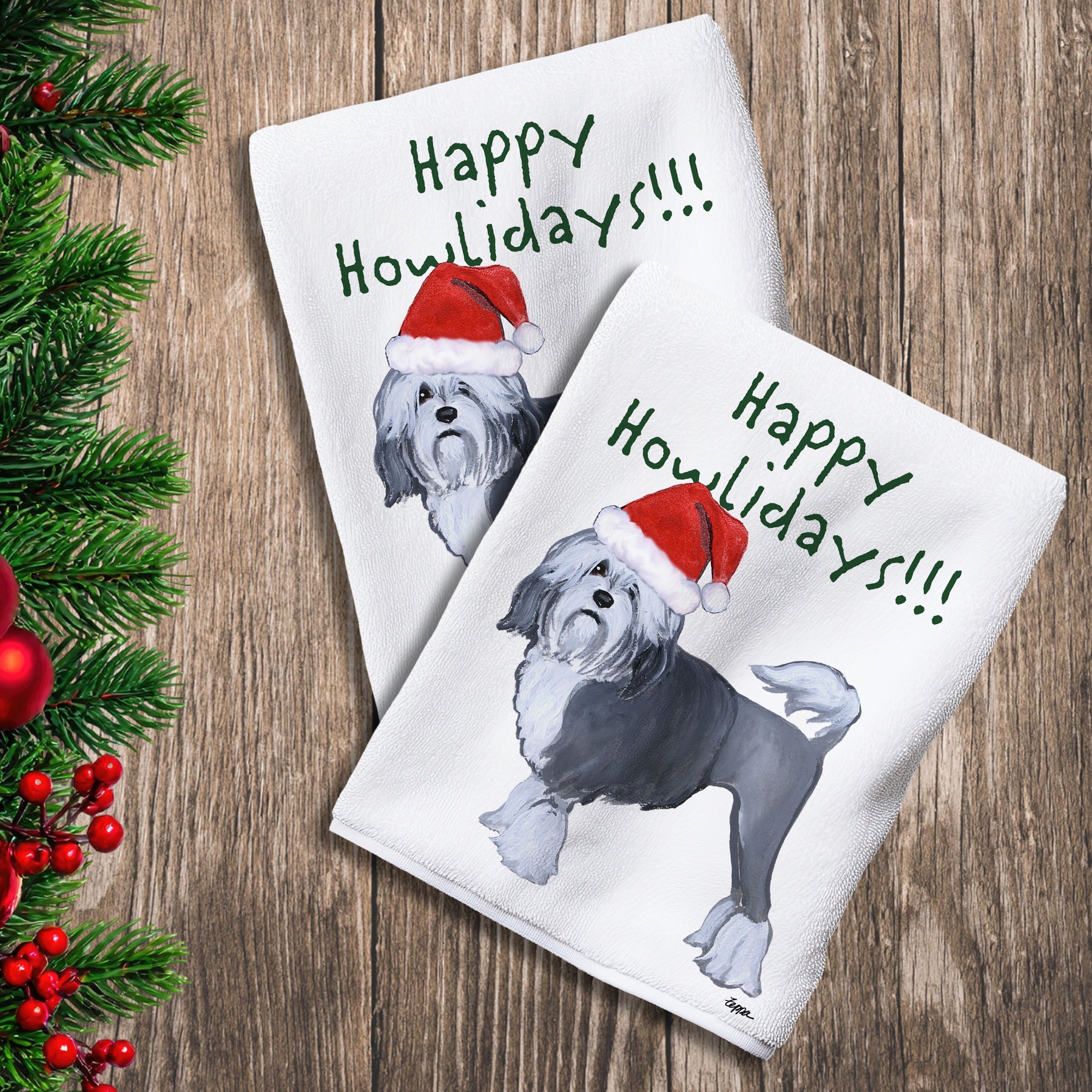 2 Kitchen Towels with a Lowchen in a Santa Hat and Happy Howlidays text.
