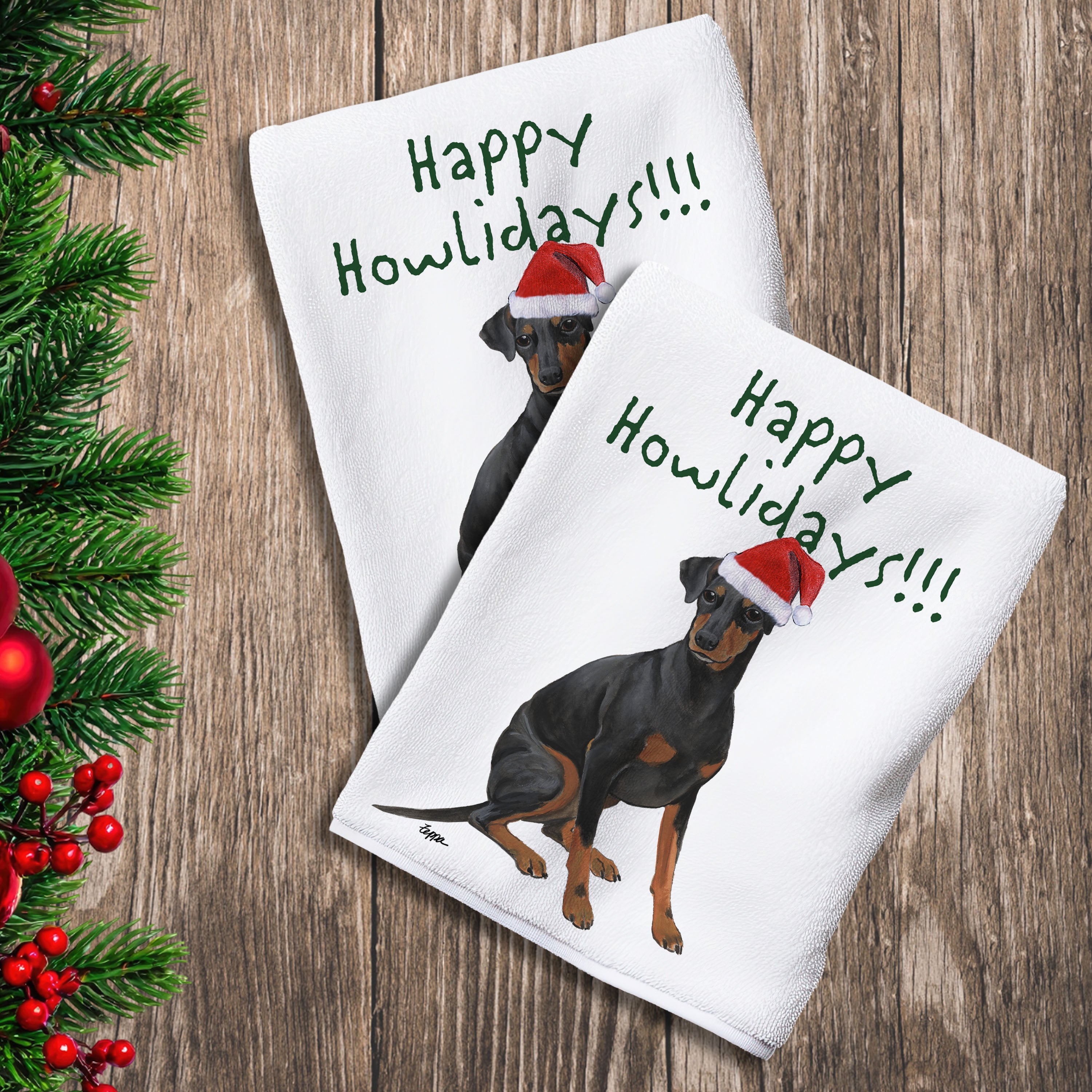 2 Kitchen Towels with a Manchester Terrier in a Santa Hat and Happy Howlidays text.