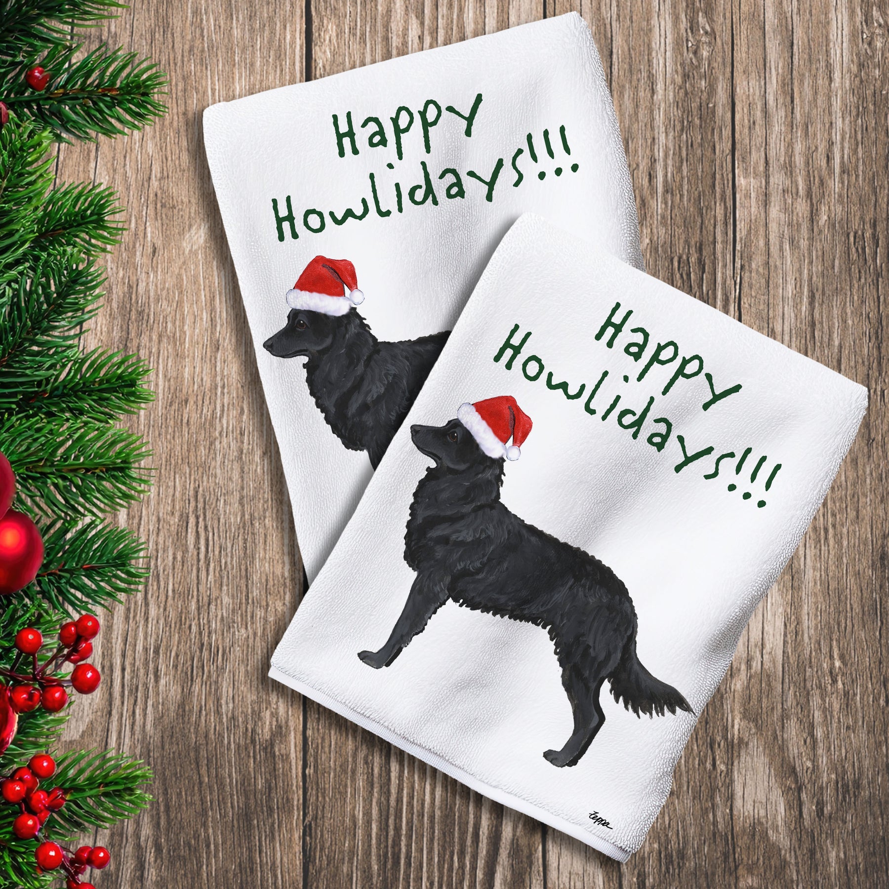 2 Kitchen Towels with a Mudi in a Santa Hat and Happy Howlidays text.