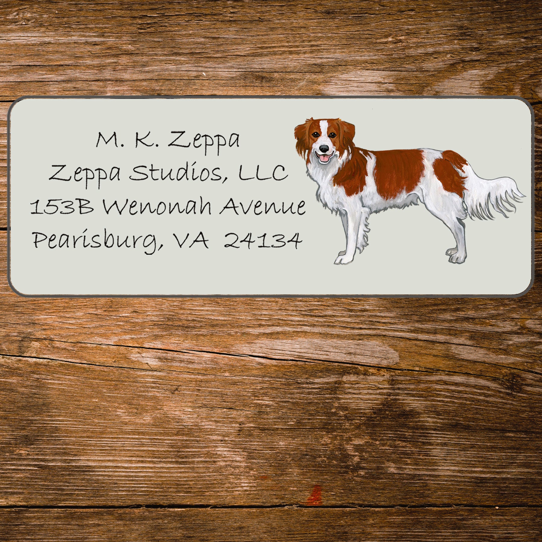 Return address label with an illustration of a Nederlandse Kooikerhondje 
