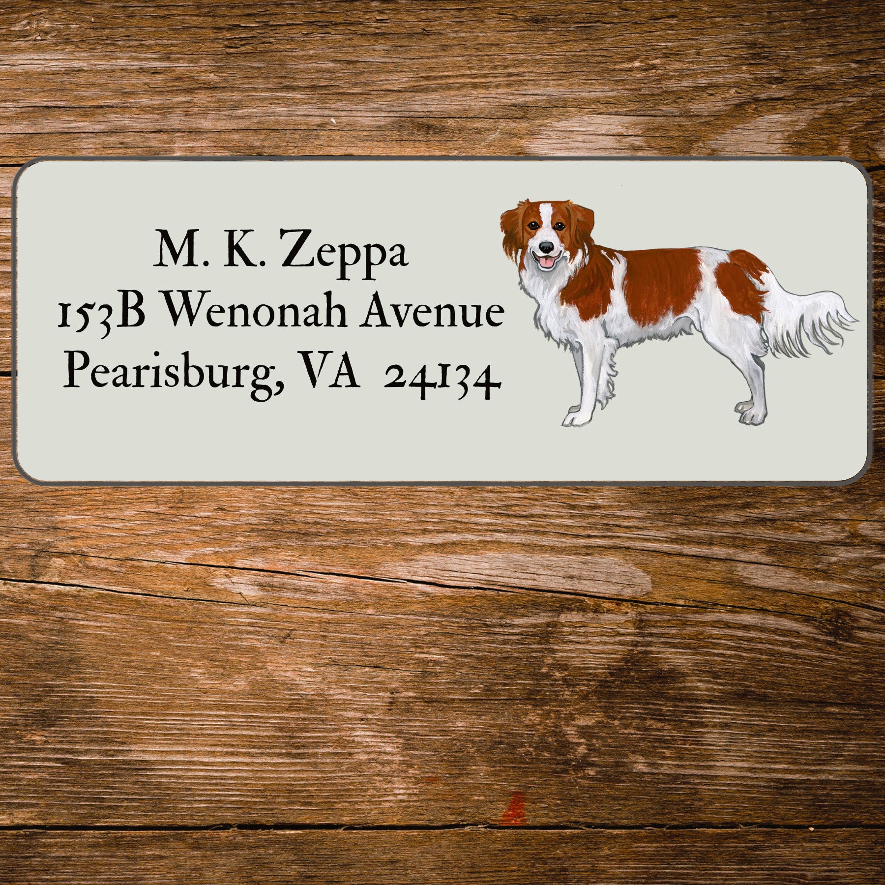 Return address label with an illustration of a Nederlandse Kooikerhondje 