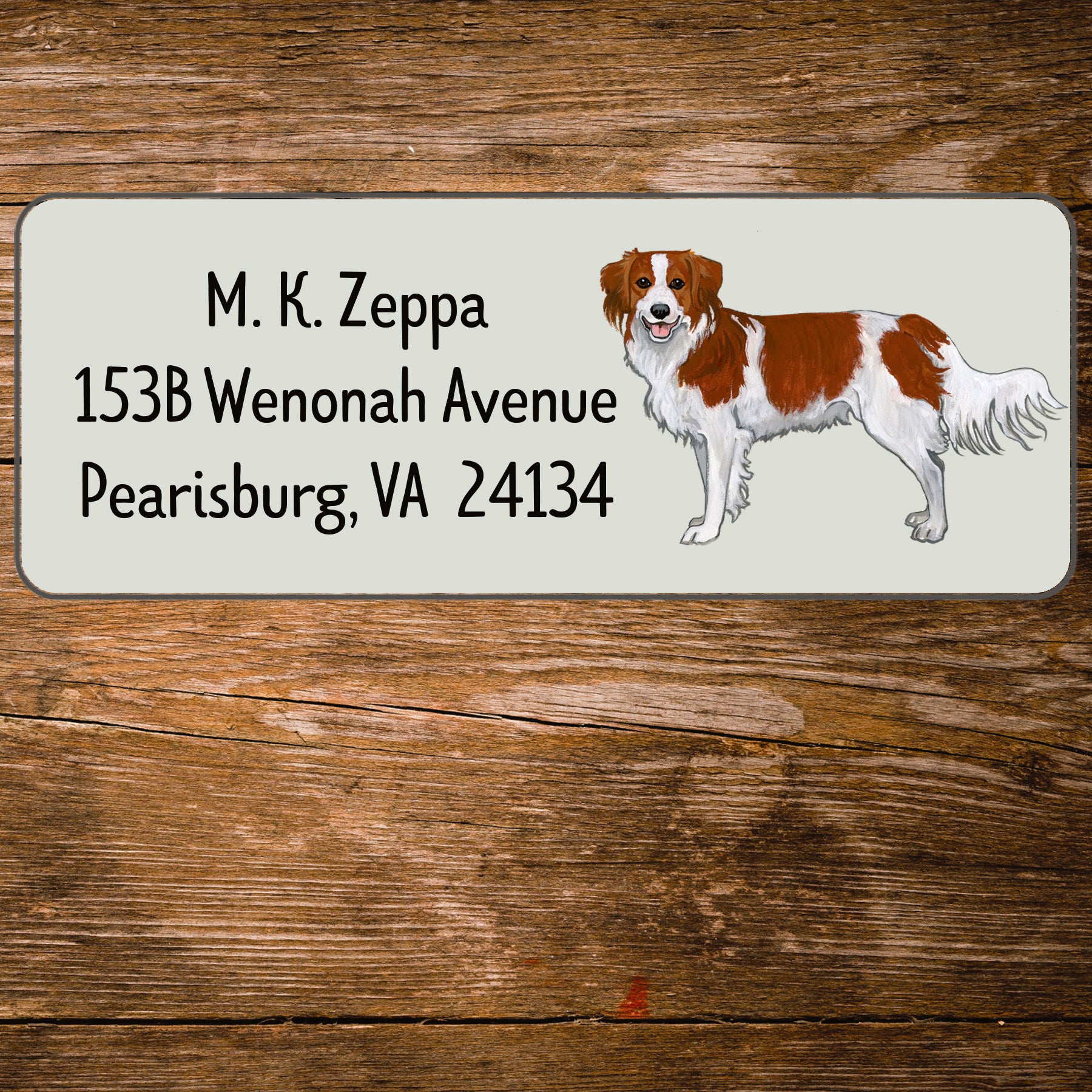 Return address label with an illustration of a Nederlandse Kooikerhondje 