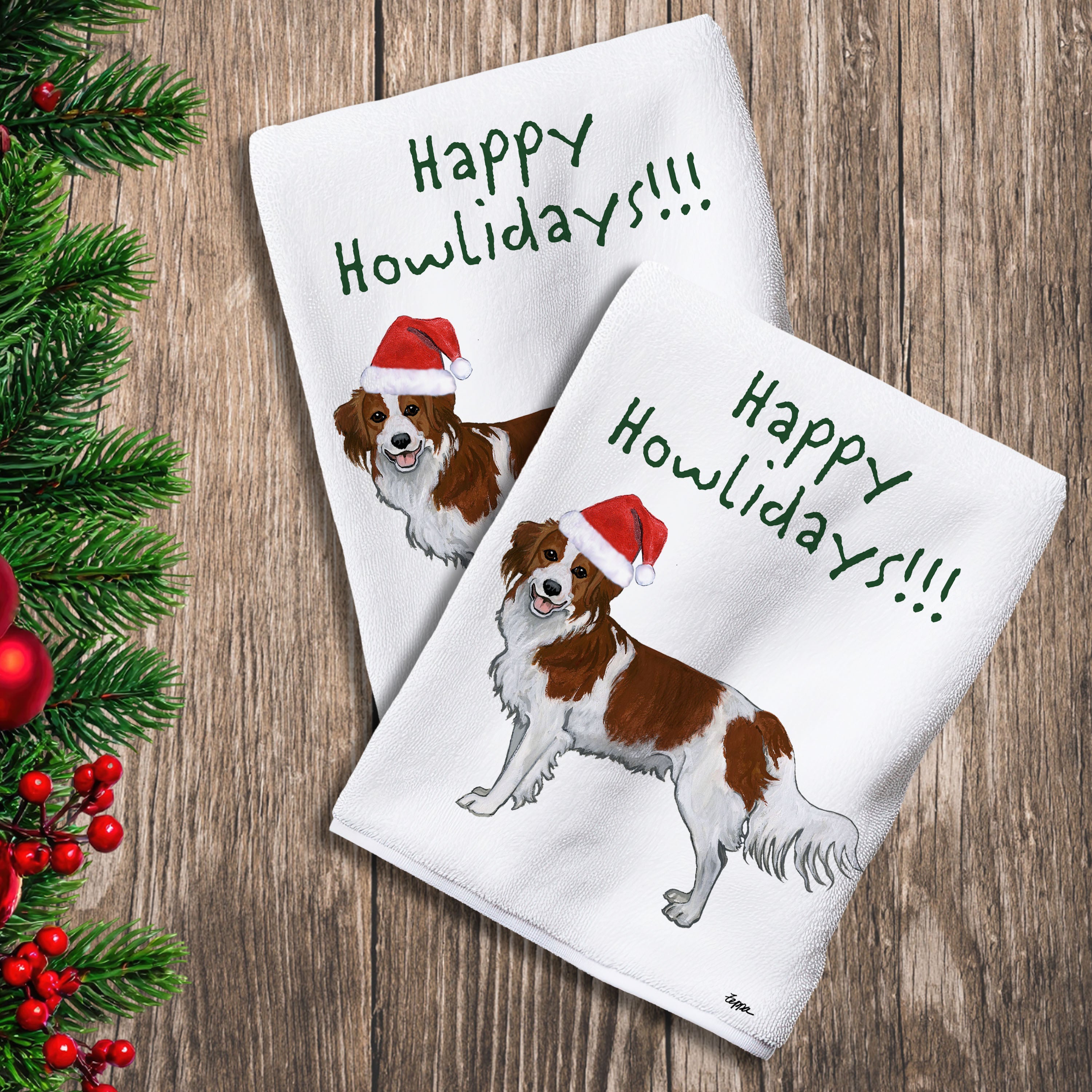 2 Kitchen Towels with a Nederlandse Kooikerhondje in a Santa Hat and Happy Howlidays text.