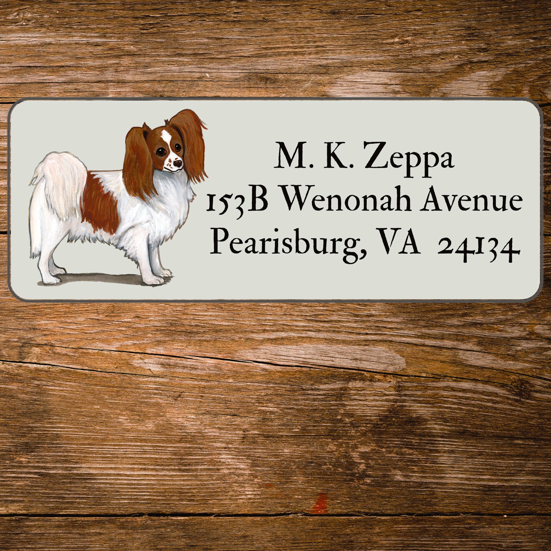 Return address label with a Papillon dog illustration.