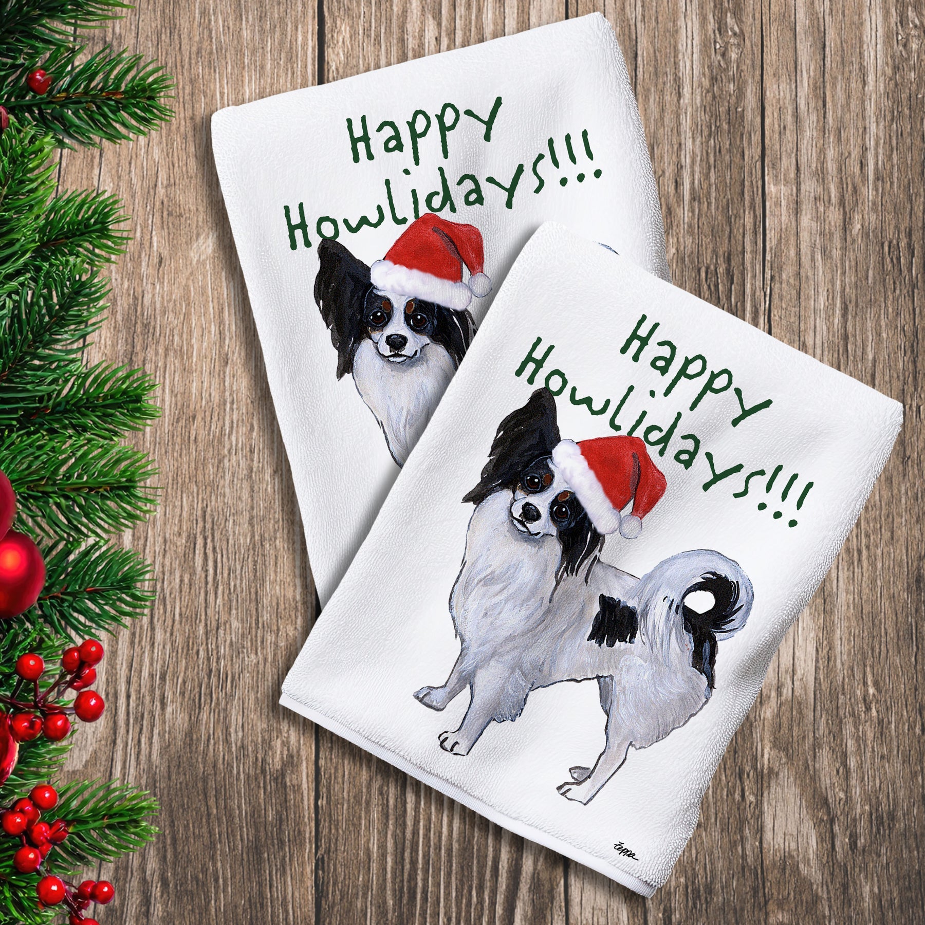 2 Kitchen Towels with a Papillon in a Santa Hat and Happy Howlidays text.
