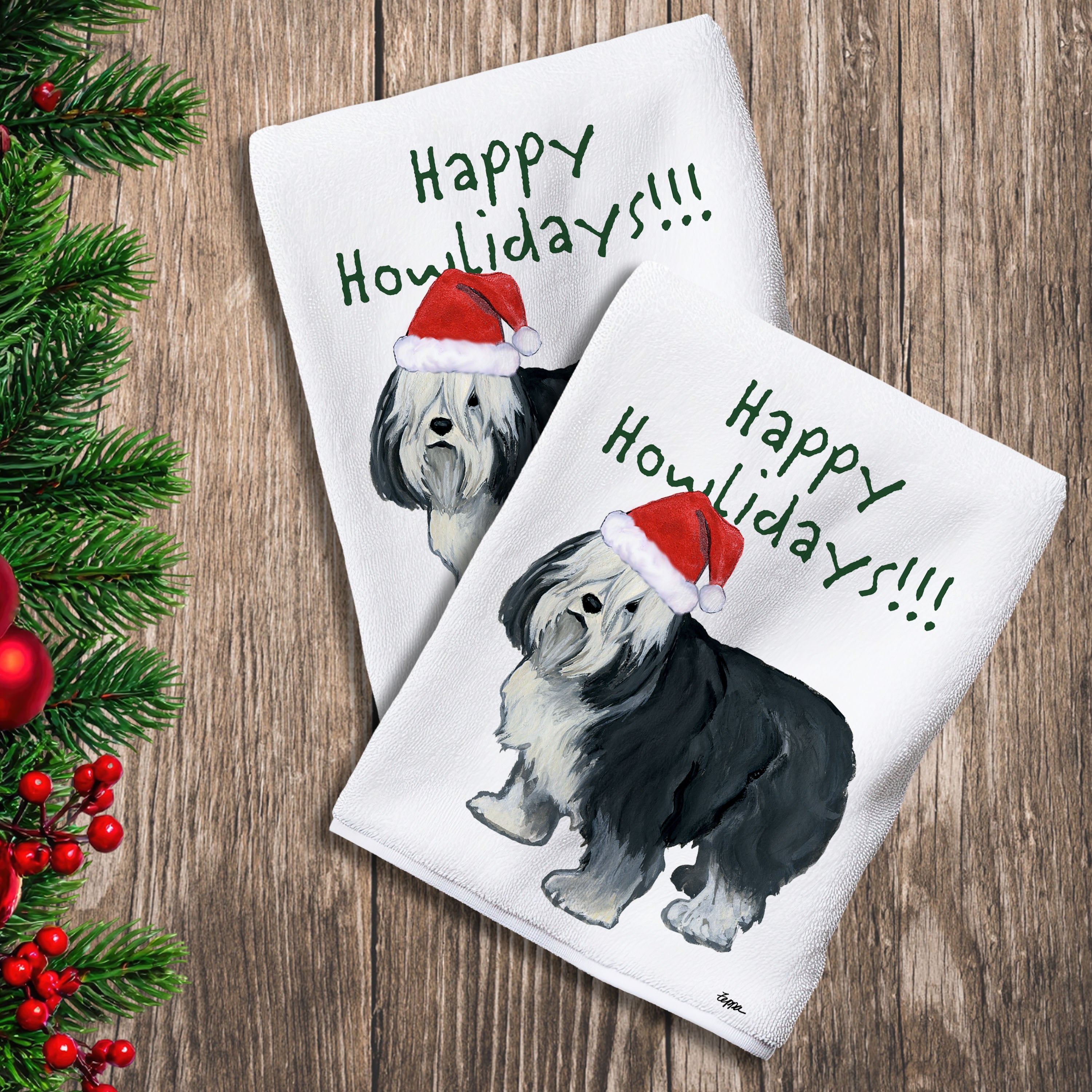 2 Kitchen Towels with a Polish Lowland Sheepdog in a Santa Hat and Happy Howlidays text.
