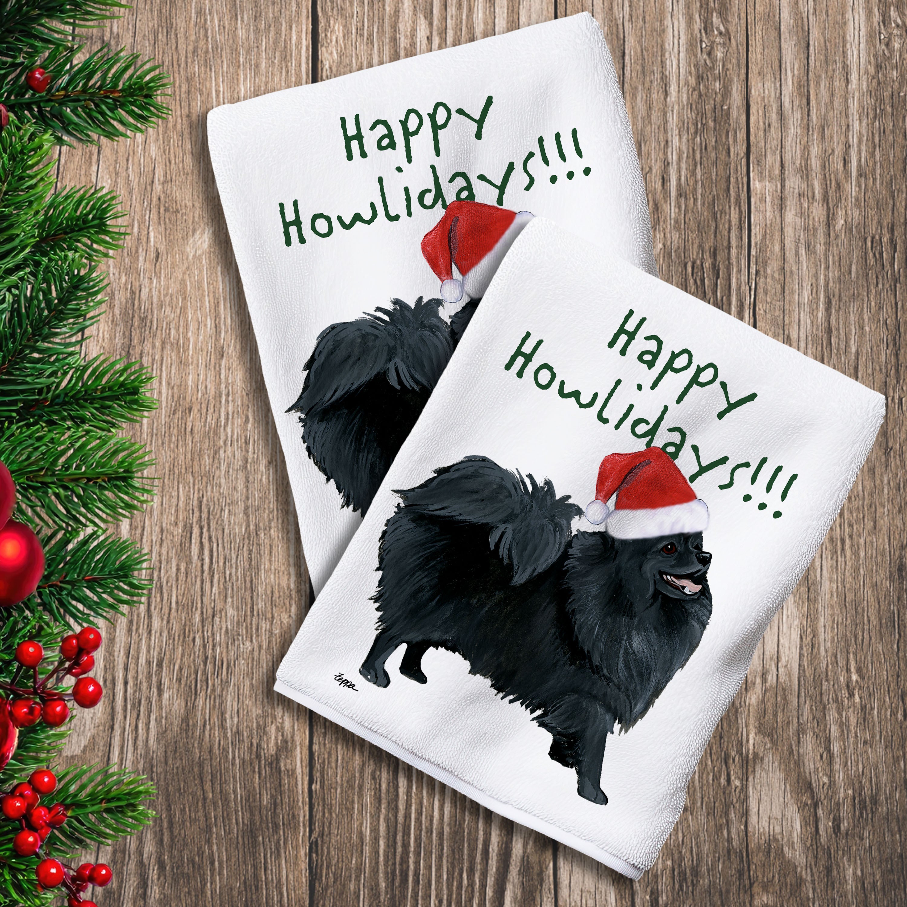 2 Kitchen Towels with a black Pomeranian in a Santa Hat and Happy Howlidays text.
